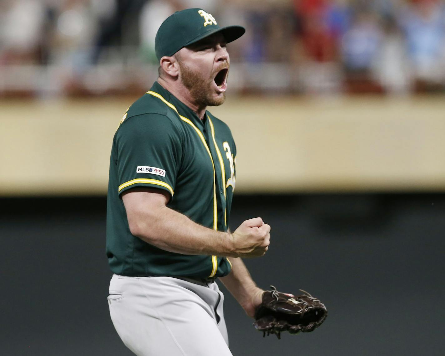 Oakland Athletics pitcher Liam Hendriks celebrates after Minnesota Twins' Mitch Garver grounded into a double play to end the baseball game Saturday, July 20, 2019, in Minneapolis. The Athletics won 5-4. Hendriks got the save. (AP Photo/Jim Mone)