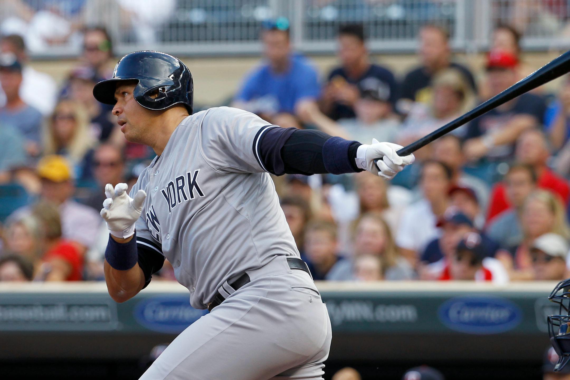 Yankees designated hitter Alex Rodriguez follows through on a single to center off Twins starter Phil Hughes during the first inning Friday.