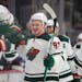 Minnesota Wild left wing Kirill Kaprizov is congratulated as he passes the team box after scoring a goal in the third period of an NHL hockey game aga