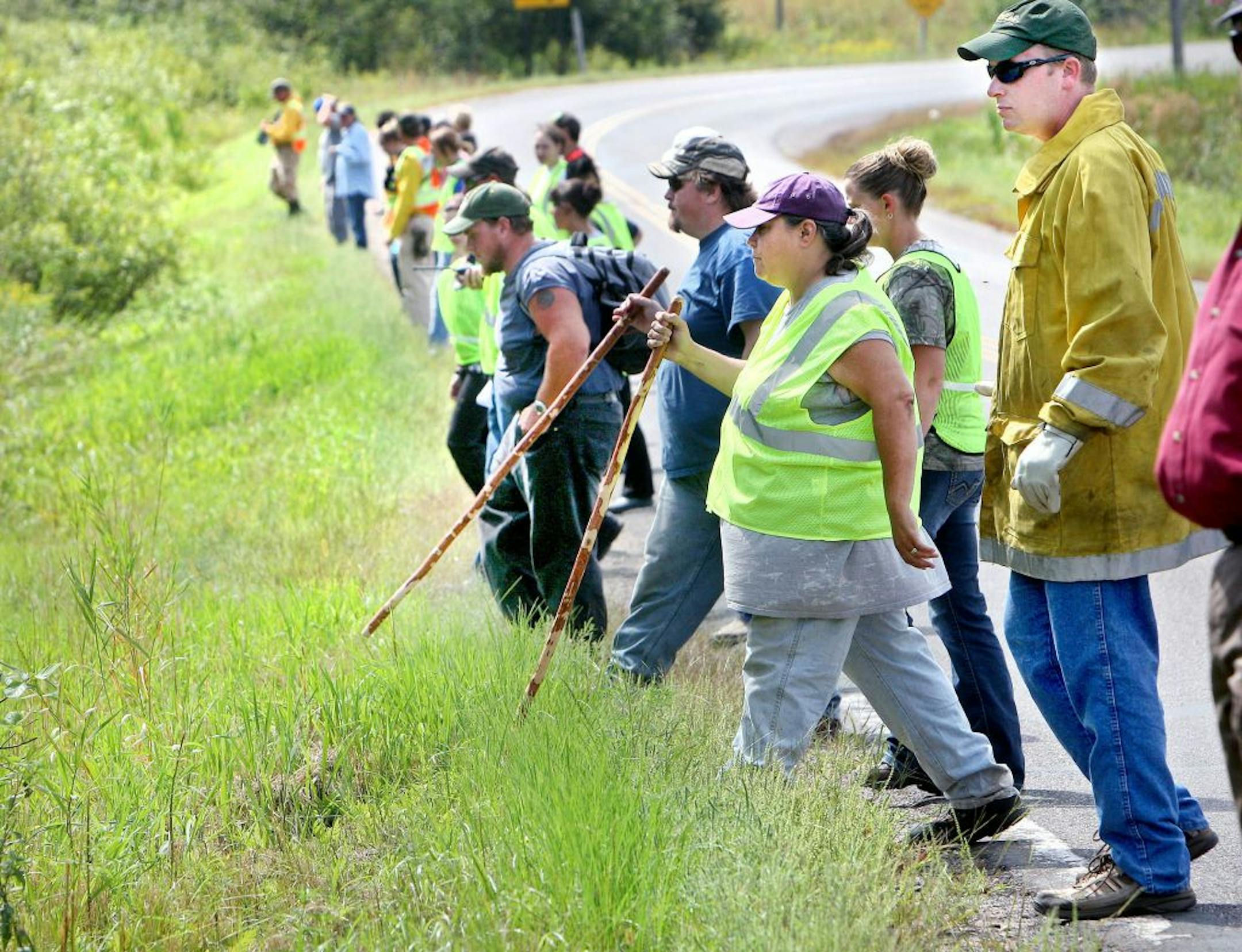 After gathering along the roadside south of Danbury, Wis., volunteers take their first steps into the forest to look for missing 3-year-old Renna Williams Wednesday, Aug. 15, 2012. Divers have found the body of a missing 3-year-old girl in a canal near her home in northwestern Wisconsin. Burnett County Emergency Management Director Rhonda Reynolds says the body of Renna Williams was found at about 4:50 p.m. Wednesday about 25 yards from her home in Danbury. Renna disappeared after apparently wan