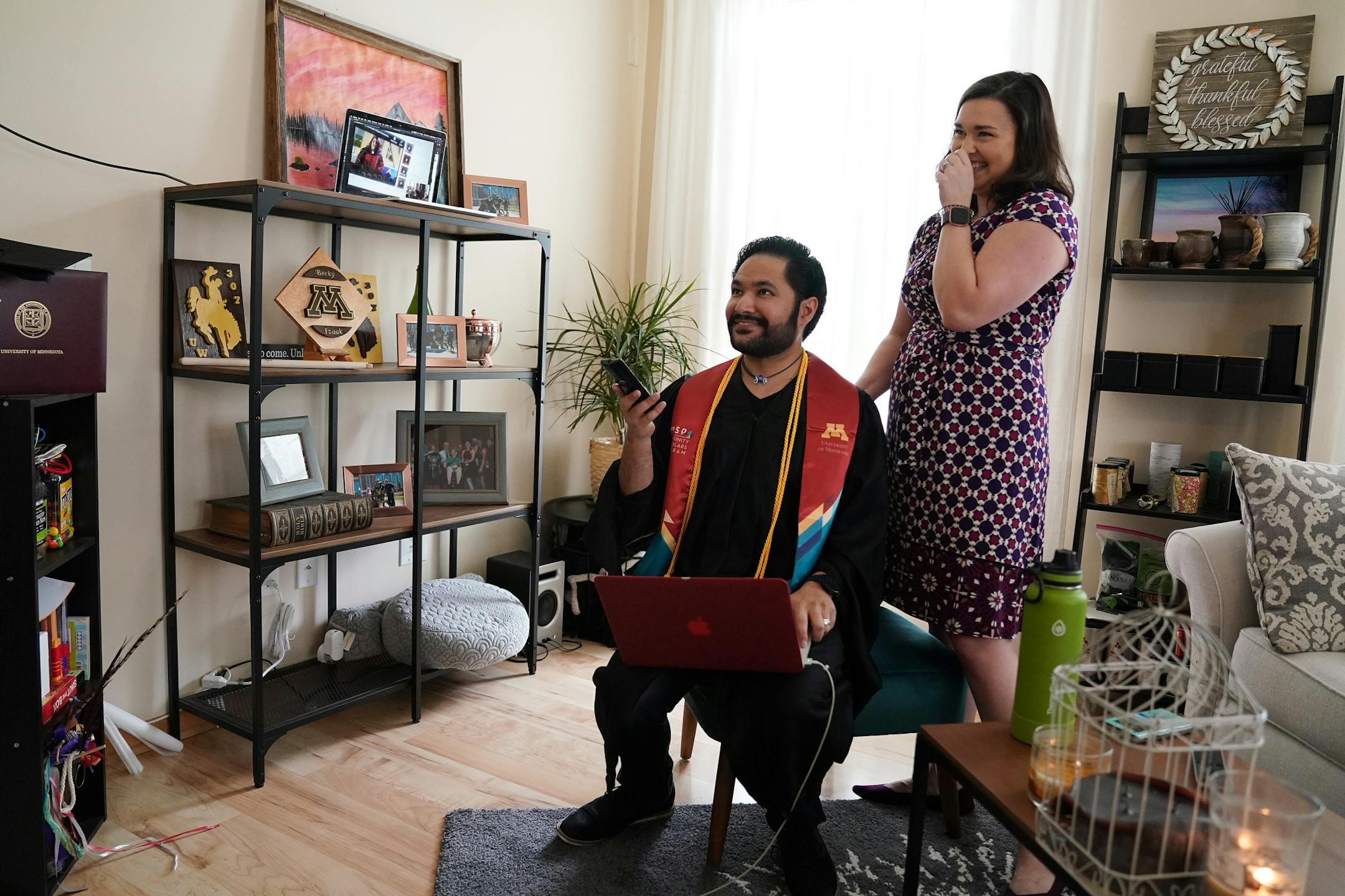 Izaak Mendoza navigated to the video commencement address in his graduation robes alongside his wife Becky and his family who were on a video call from their home in Wyoming Saturday.