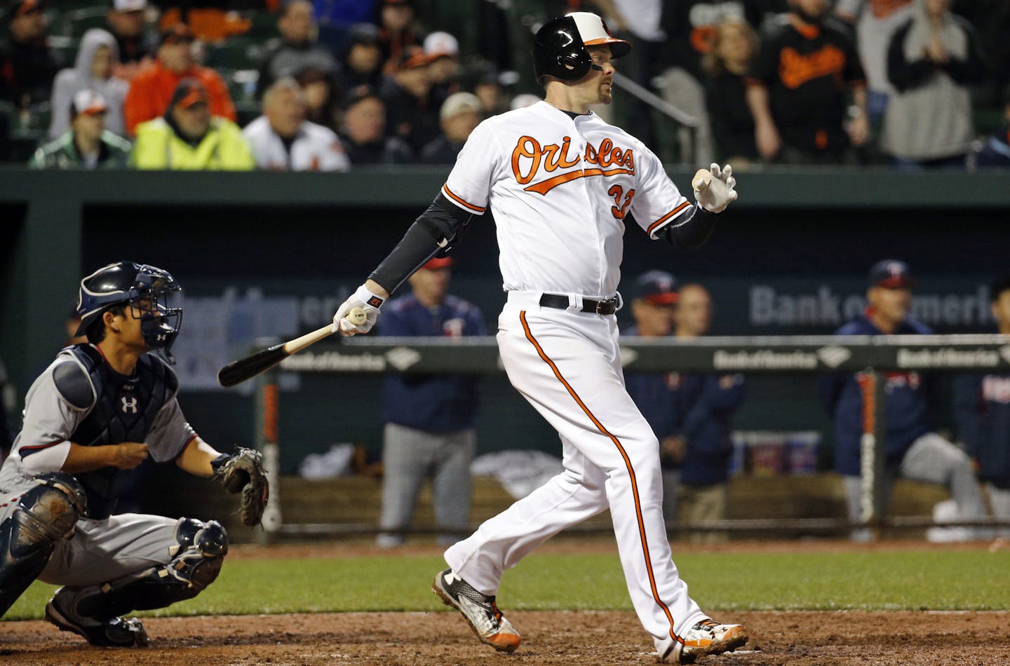 Baltimore Orioles' Matt Wieters, right, follows through on a game-winning single in front of Minnesota Twins catcher Kurt Suzuki in the ninth inning of an opening day baseball game in Baltimore, Monday, April 4, 2016. Chris Davis scored on the play, and Baltimore won 3-2. (AP Photo/Patrick Semansky)