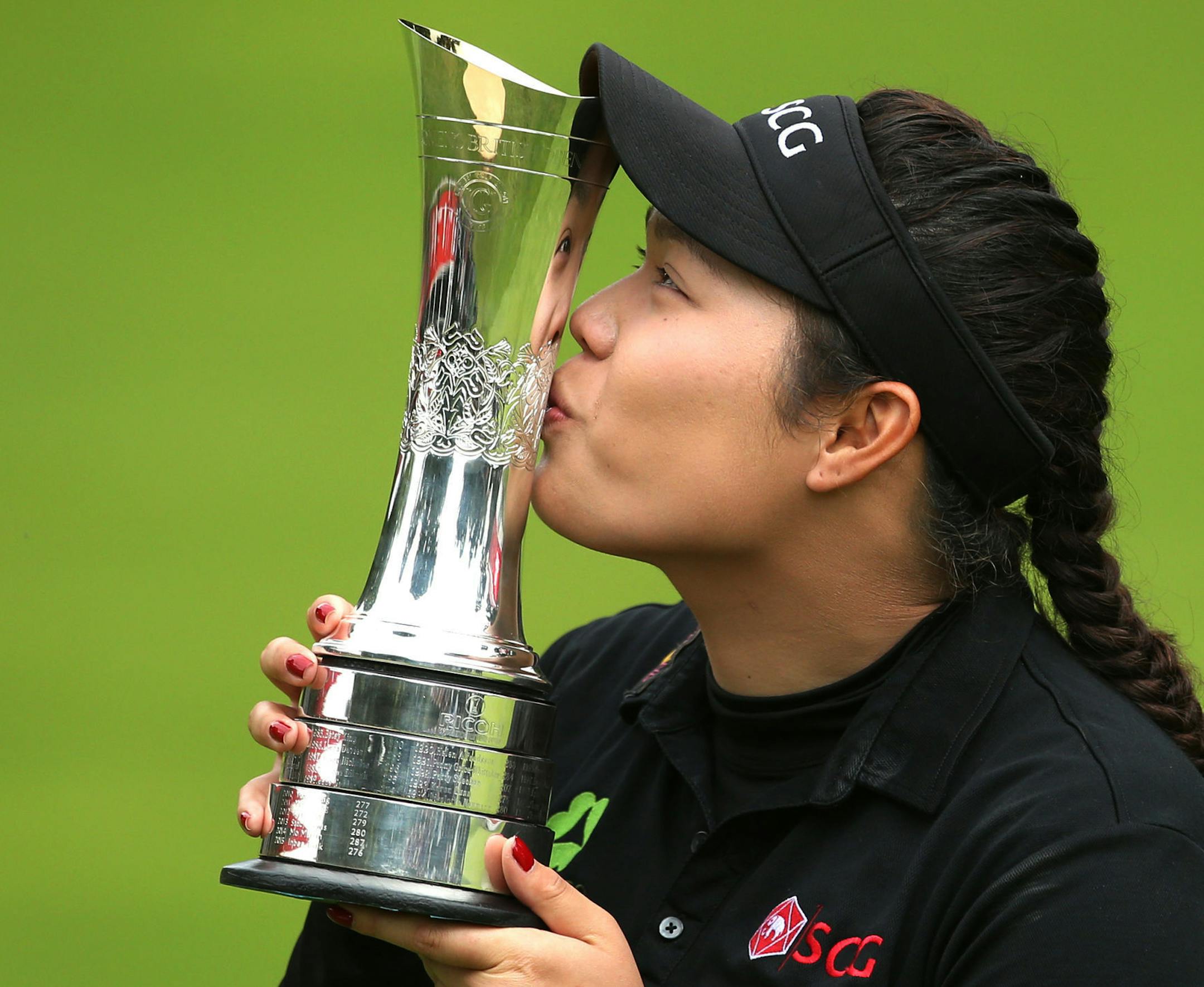 Thailand's Ariya Jutanugarn poses with her trophy after winning the Women's British Open during day four of the Women's British Open at Woburn Golf Club, Woburn, England, Sunday July 31, 2016. (Steve Paston / PA via AP)
