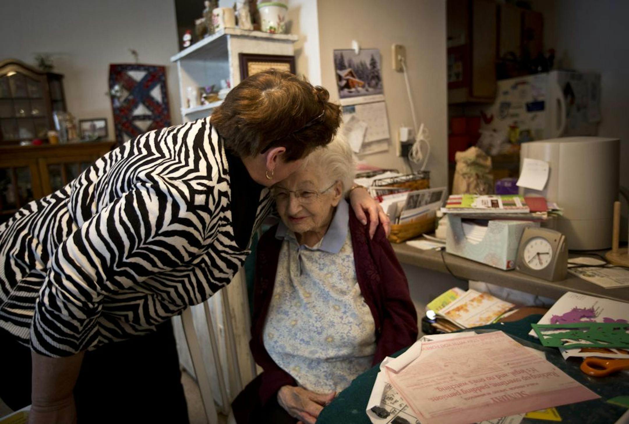 Property manager Peggy Auchter gave Vivian Henningfield, 91, a hug and kiss on the forehead as she left in Henningfield's apartment on December 20, 2012 in Little Canada, Minn. Henningfield, 91, lives in an apartment complex owned by nonprofit CommonBond, which houses immigrants, the working poor and low-income elderly and provides ancillary services including youth tutoring, skill-development and activities for elderly residents that keeps them independent and out of hugely expensive nursing ho
