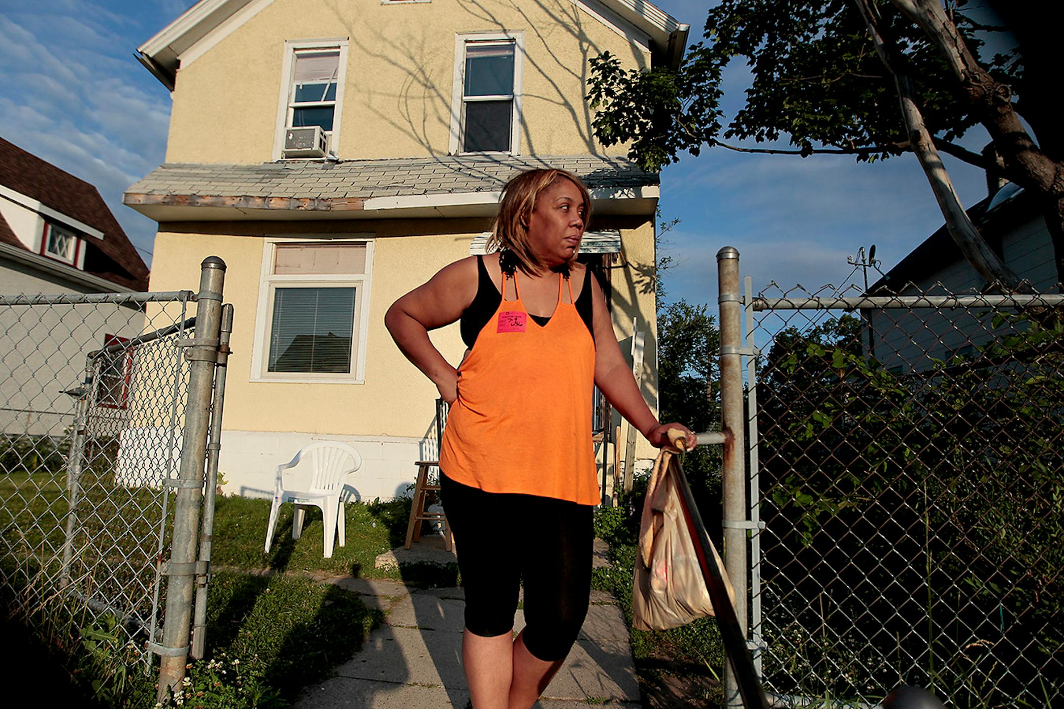 Sherrillyn Mosley stood in front of her home where her daughter Asia Mosley was shot in the back yard July 9, 2014, in Minneapolis.