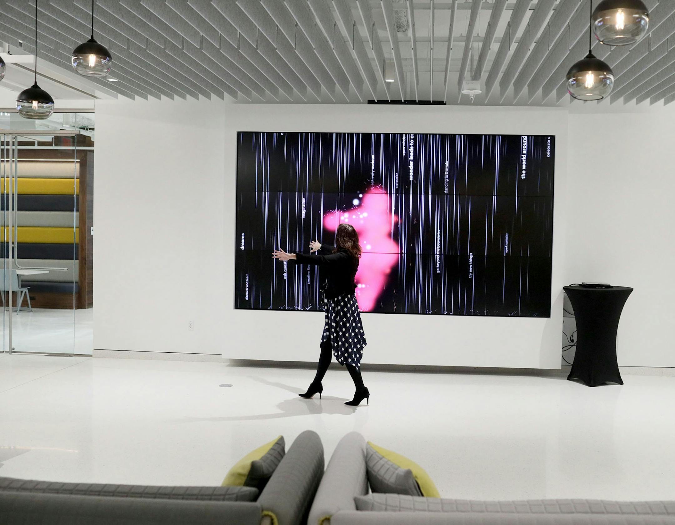 3M opens new consumer data-science lab to help customers make retail store and product display decisions. Here, a giant video screen interacts with the movements of Jessica Hack 3M account manager in the Data Sciences and Merchandising lobby Tuesday, Feb. 26, 2019, in Maplewood, MN.