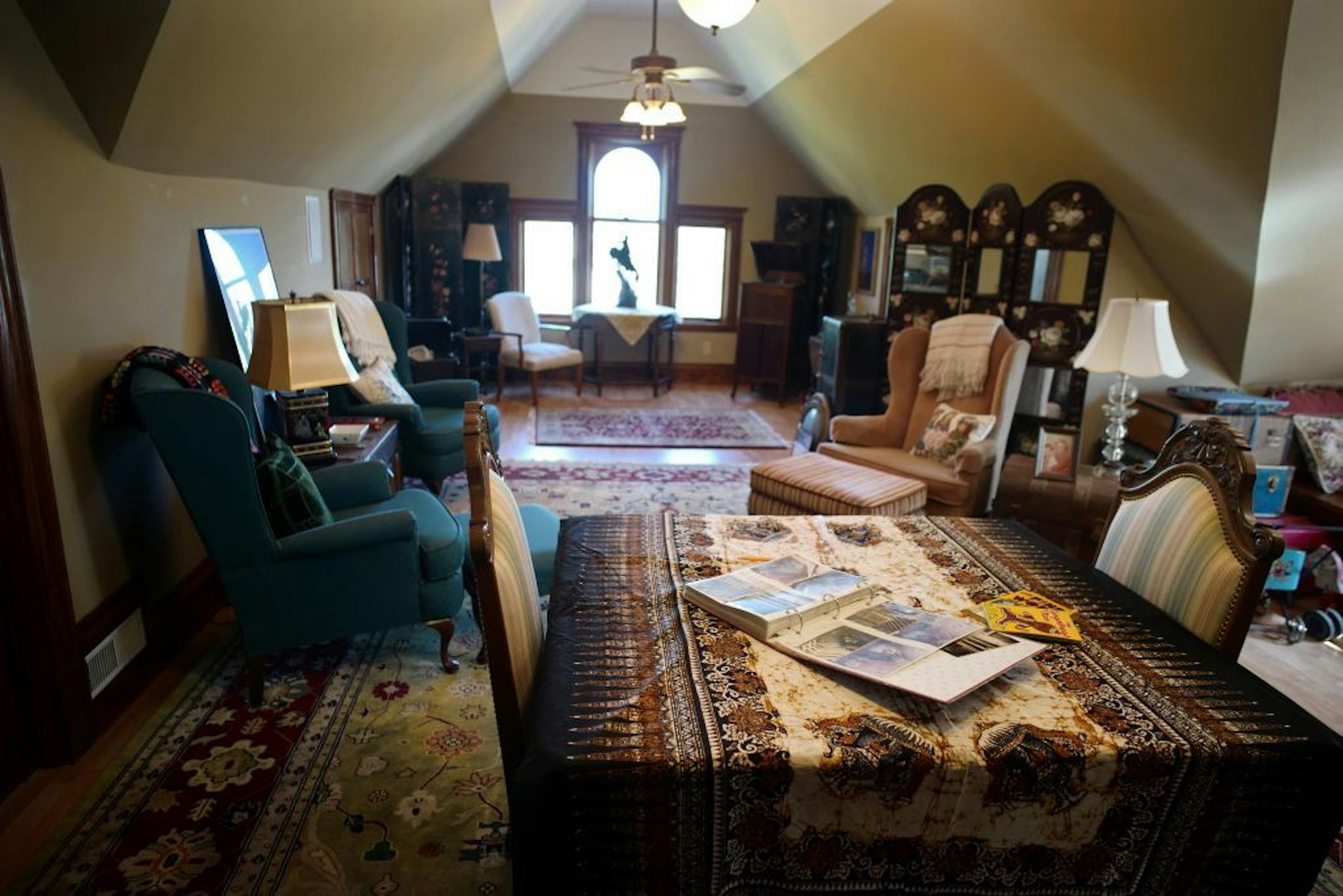 Craig Pier converted his third floor attic into a great room, guest bedroom and bathroom furnished with antiques.