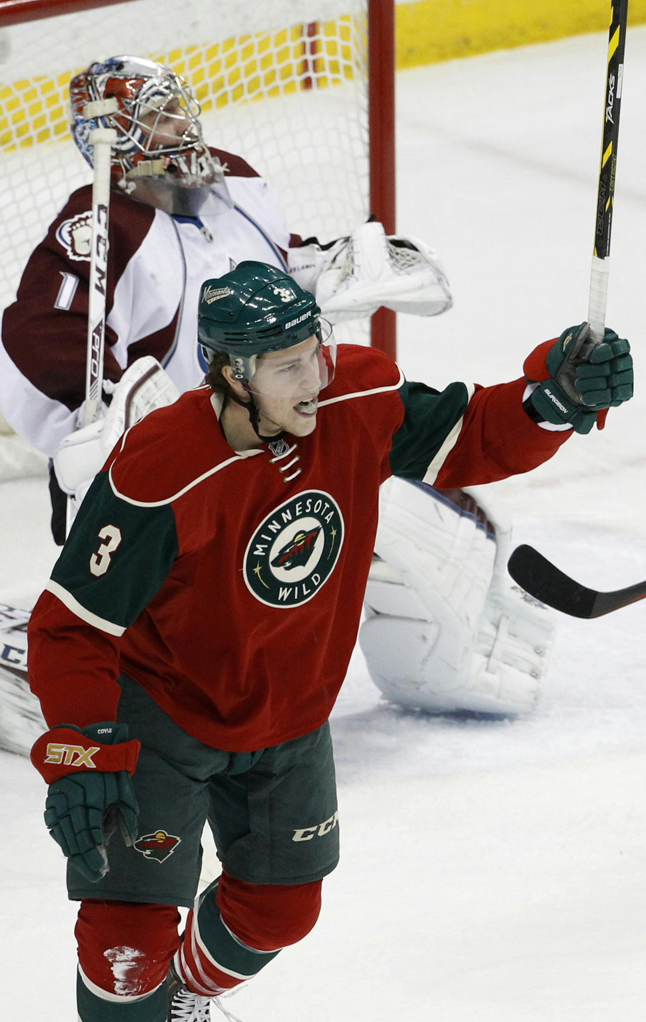 Minnesota Wild center Charlie Coyle (3) celebrates after scoring on Colorado Avalanche goalie Semyon Varlamov, rear, of Russia, during the first period of an NHL hockey game in St. Paul, Minn., Saturday, Feb. 7, 2015. The Wild won 1-0. (AP Photo/Ann Heisenfelt)