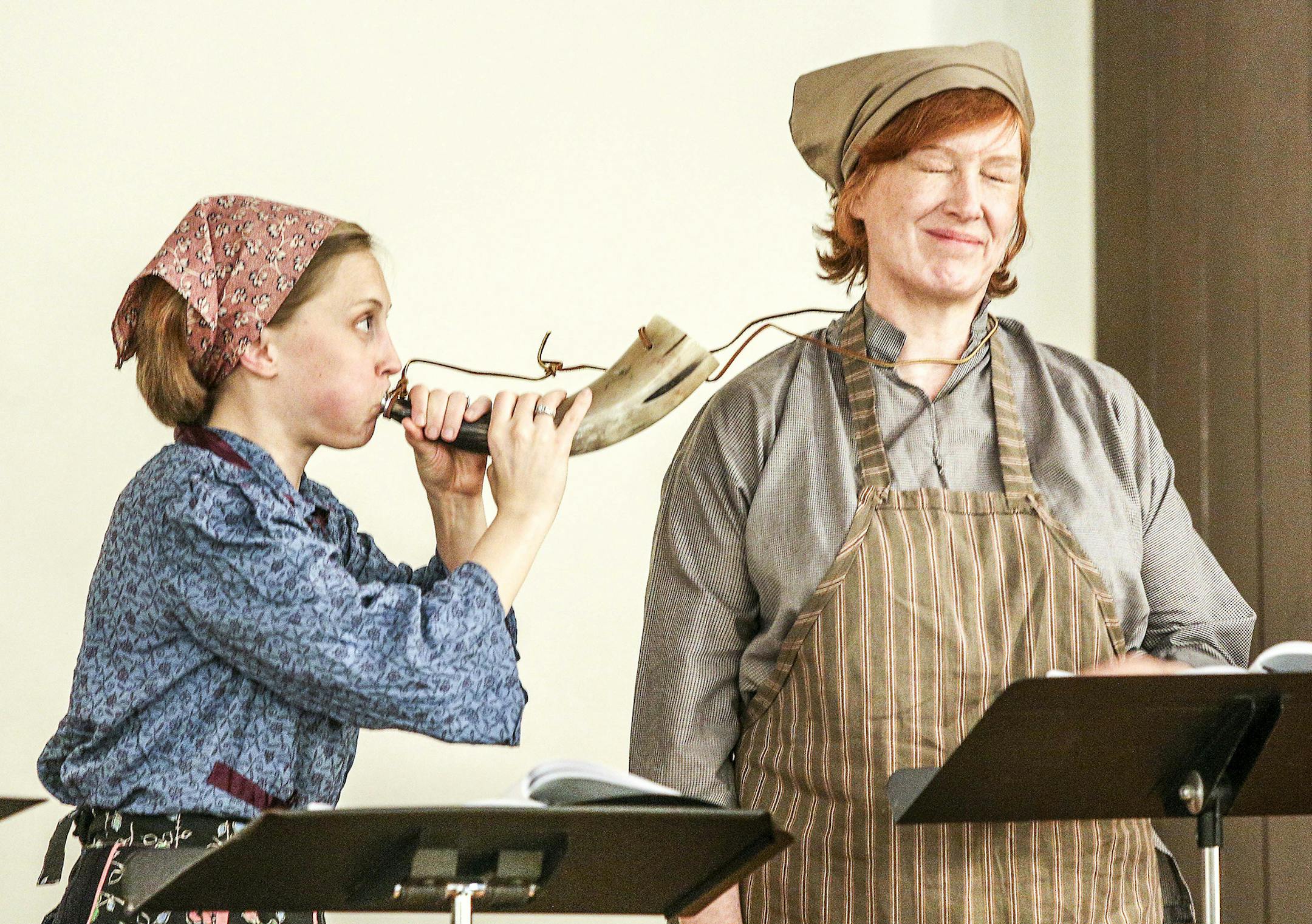 Rose Arrowhead DeCoux blows Mary Lee's cow horn during a rehearsal for "Cow Calls in Dalarna" a play by Barton Sutter about women who worked the pastures in a Swedish Village. (Clint Austin / caustin@duluthnews.com)