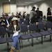Immigrants, along with spouses or friends, sit in a waiting room at the US Customs and Immigration Services offices Thursday, Feb. 6, 2014, in Bloomin