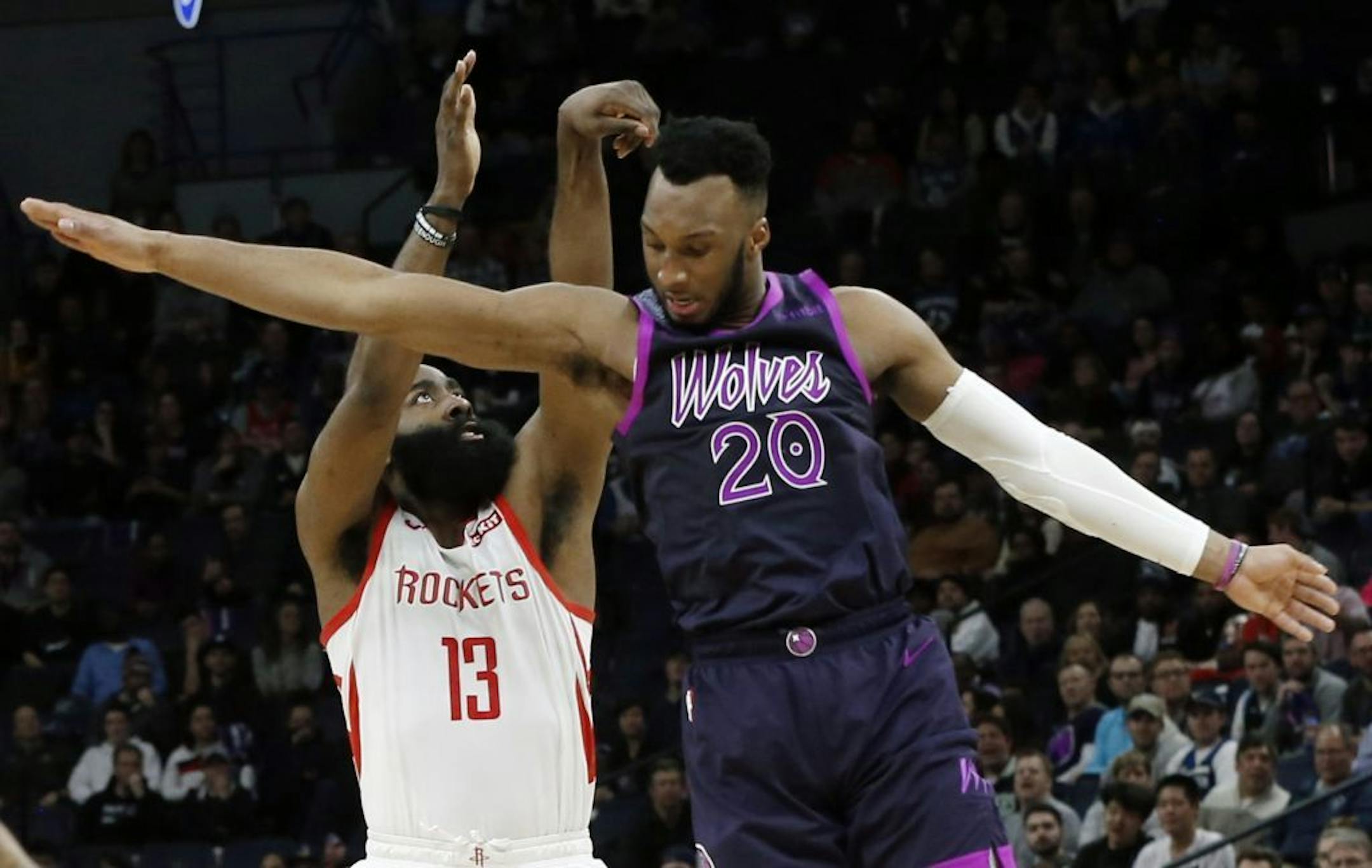 Houston Rockets' James Harden, left, follows through on a shot as Minnesota Timberwolves' Josh Okogie jumps past him in the second half of an NBA basketball game, Wednesday, Feb. 13, 2019, in Minneapolis. The Timberwolves won 121-111. Harden scored 42 points.