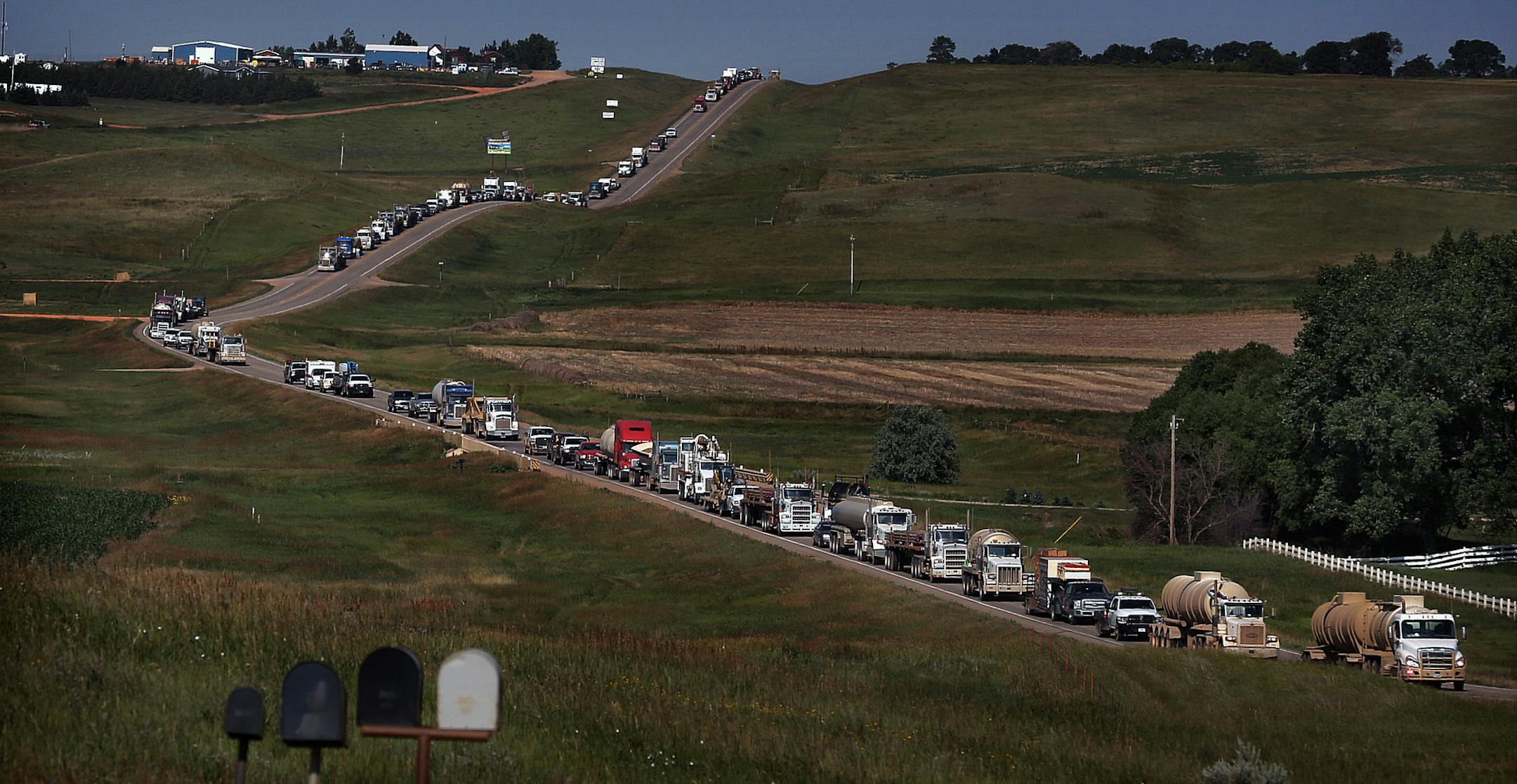 Traffic related to servicing the oil boom has increased dramatically, taxing roads that were not designed to carry such a heavy load. These trucks were lined up along a road near Watford City. ] (JIM GEHRZ/STAR TRIBUNE) / December 10, 2013, Williston/Napoleon, ND ‚Äì BACKGROUND INFORMATION- PHOTOS FOR USE IN FIFTH PART OF NORTH DAKOTA OIL BOOM PROJECT: While many have migrated to the Bakken oil fields in search of fortune and adventure, others have chosen to leave the region as