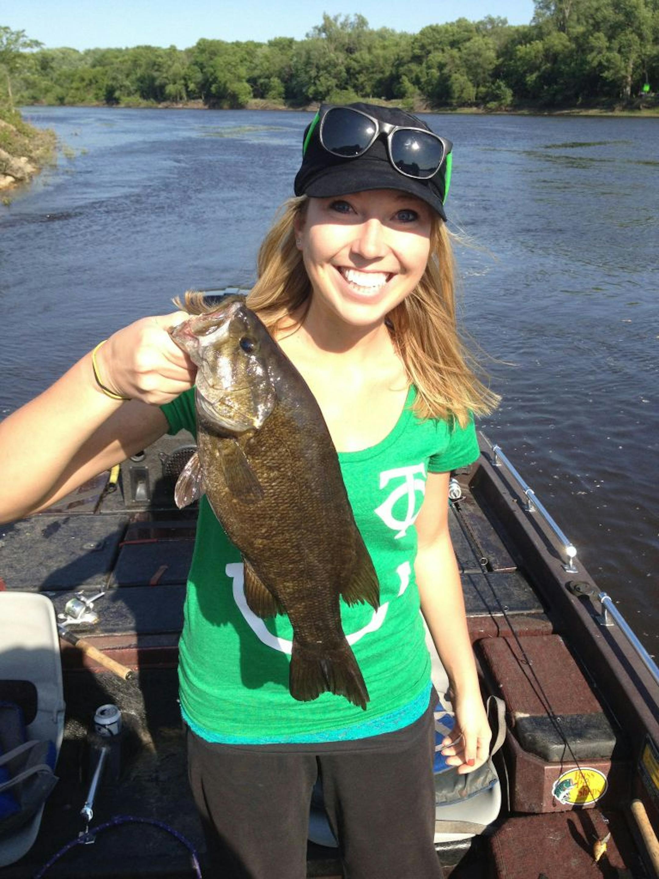 Meghan Kane of Apple Valley with an 18.5-inch smallmouth bass she caught and released on the Mississippi River in St. Paul.