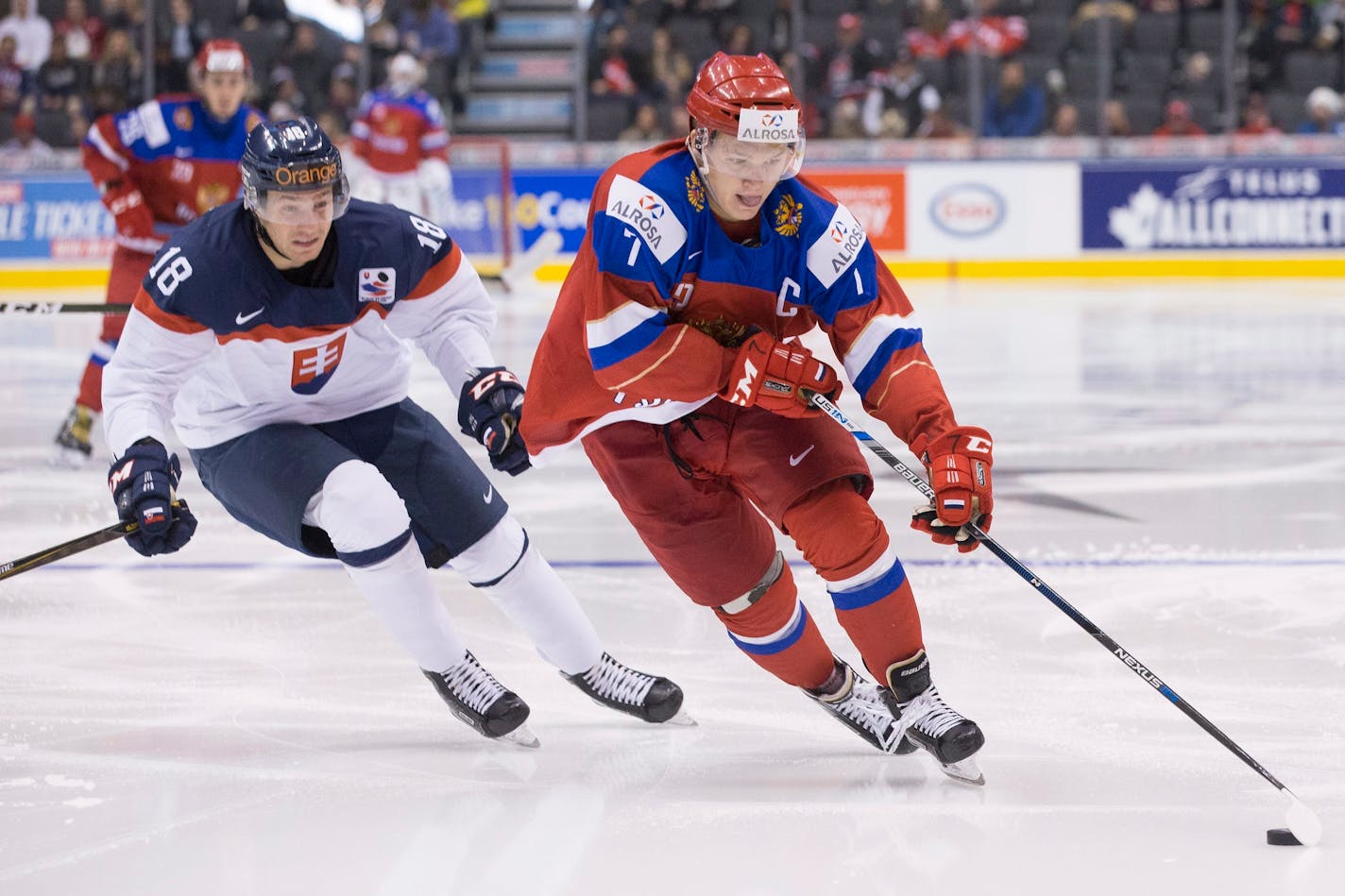 Russia's Kirill Kaprizov skates past Slovakia's Boris Sadecky during the third period of a world junior championship hockey game in Toronto on Saturday, Dec. 31, 2016. (Chris Young/The Canadian Press via AP)