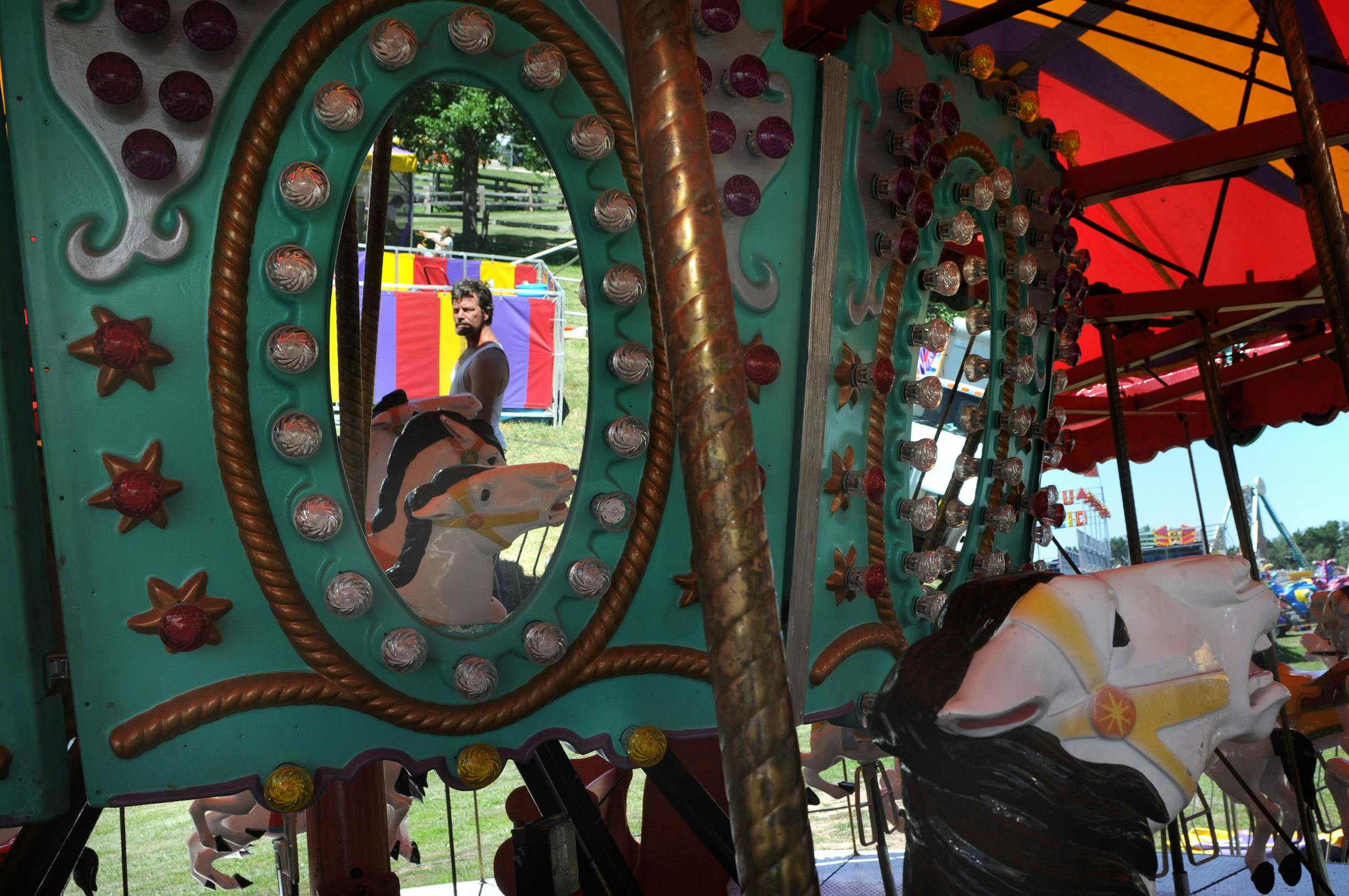 Carnival workers set up the merry-go-round Tuesday at the Washington County fairgrounds in Lake Elmo in preparation for the fair's opening today