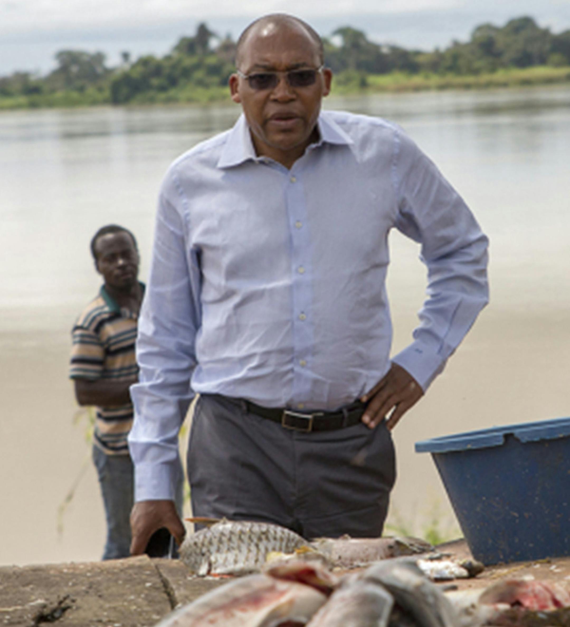 Dr. Joseph Kamgno stands on the banks of the Sanaga River in Cameroon, breeding grounds for the black flies linked to river blindness. (Brian Rinker/Kaiser Health News/TNS) ORG XMIT: 1229107