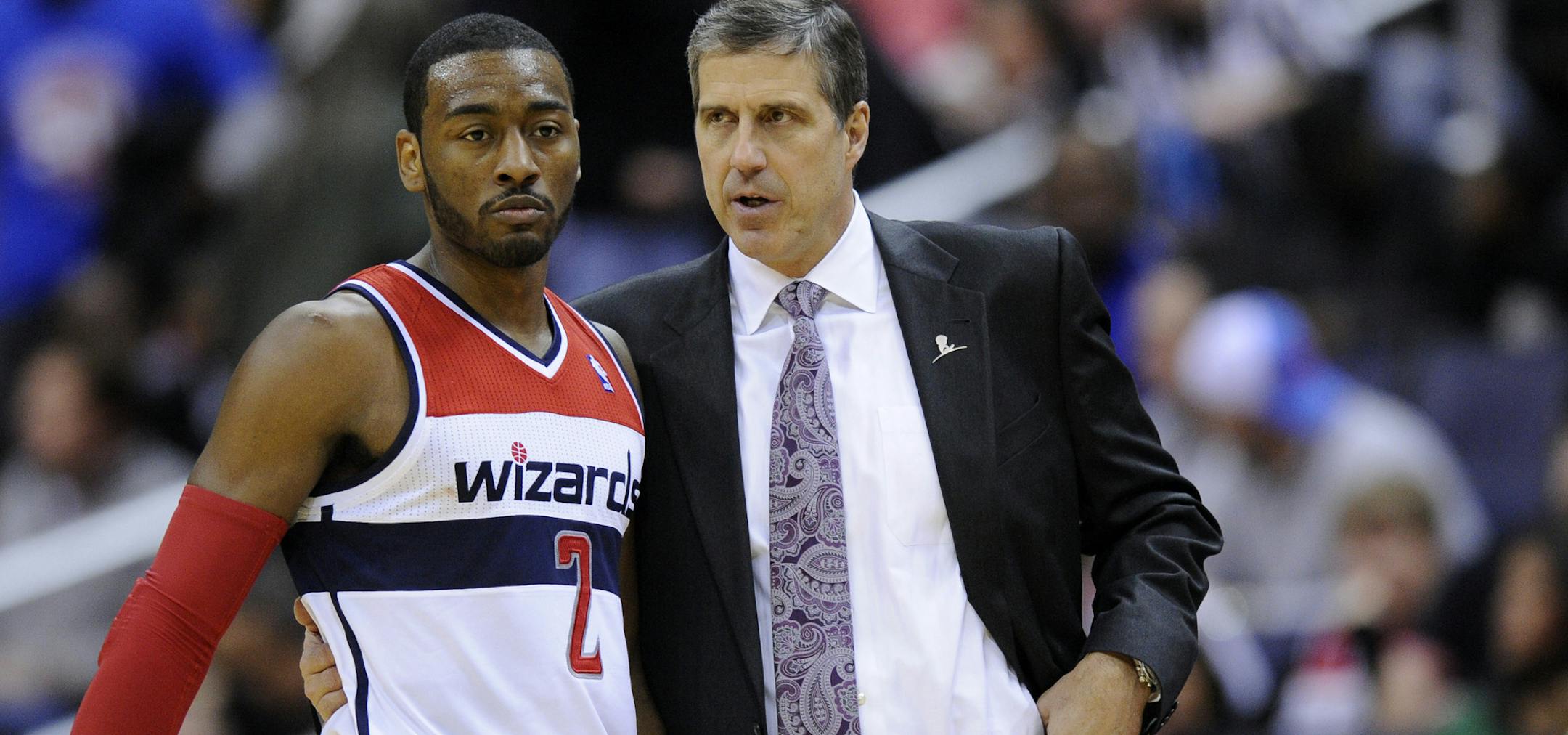 Washington Wizards head coach Randy Wittman, right, speaks with guard John Wall (2) during the second half of an NBA basketball game against the Philadelphia 76ers, Sunday, March 3, 2013, in Washington. The Wizards won 90-87. (AP Photo/Nick Wass)