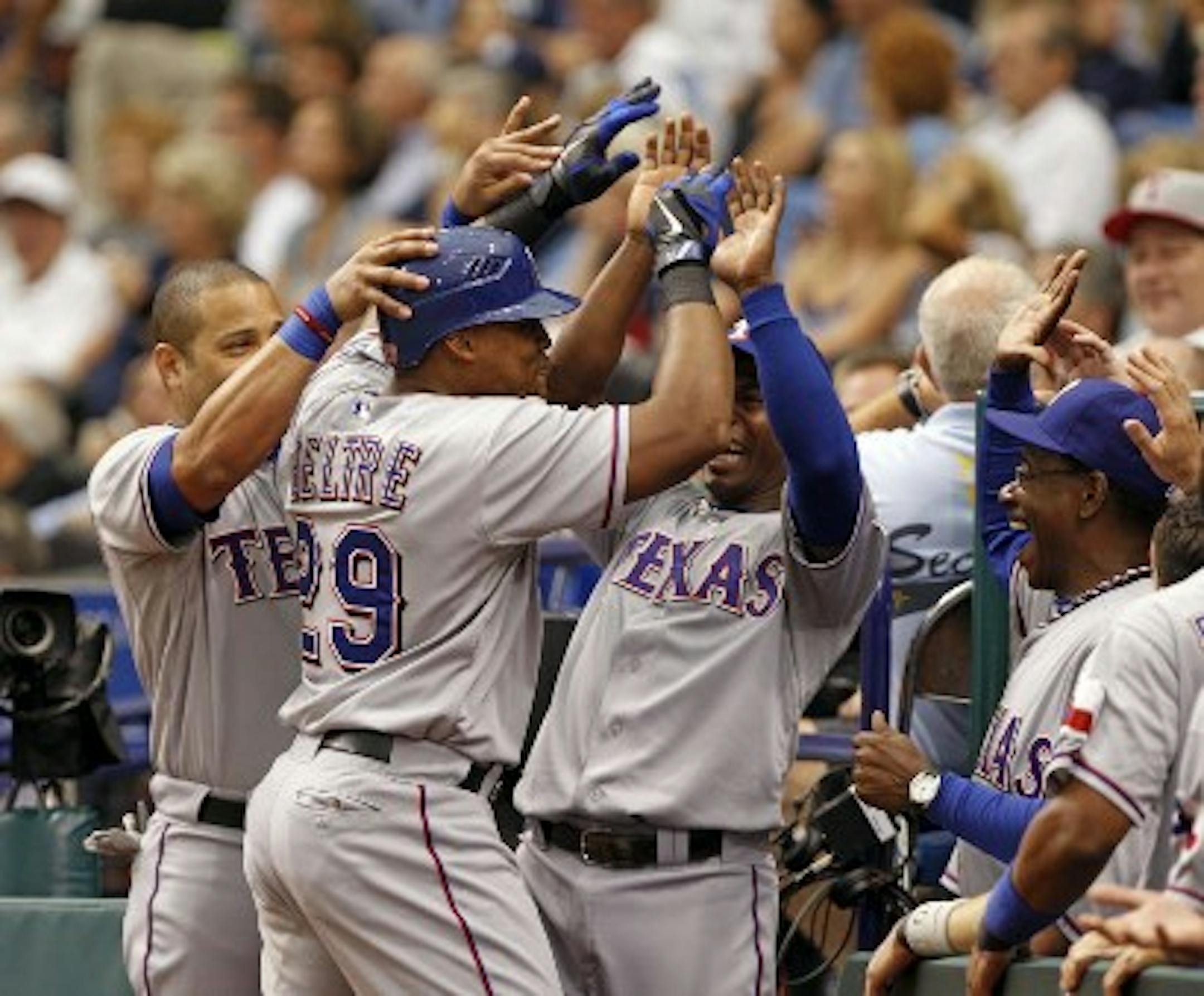 Adrian Beltre is congratulated after the second of his three home runs (so far) Tuesday. /Lynne Sladky, Associated Press