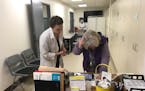 Nurse practitioner Nicole Leand (left) and Becky Fink, executive director of Nucleus Clinic, work the check-in table between appointments Tuesday at a