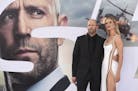 Cast member Jason Statham, left, and Rosie Huntington-Whiteley arrive at the Los Angeles premiere of "Fast & Furious Presents: Hobbs & Shaw" on Saturd