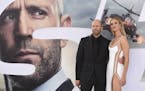 Cast member Jason Statham, left, and Rosie Huntington-Whiteley arrive at the Los Angeles premiere of "Fast & Furious Presents: Hobbs & Shaw" on Saturd