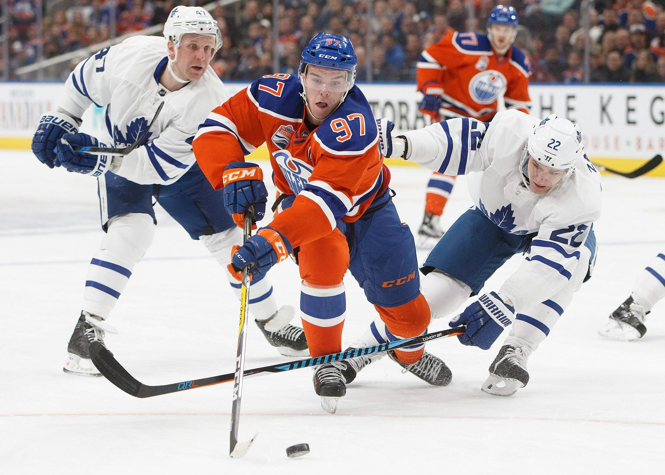 Toronto Maple Leafs' Leo Komarov (47) and Nikita Zaitsev (22) try to stop Edmonton Oilers' Connor McDavid (97) during second period NHL hockey action in Edmonton, Alberta, Tuesday Nov. 29, 2016. (Jason Franson/The Canadian Press via AP)