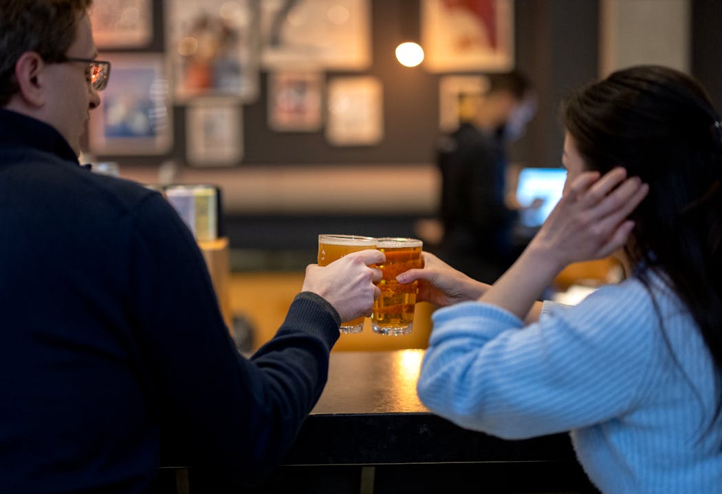 A man and woman toasted each other in the bar at The Moxy Thursday in Minneapolis.