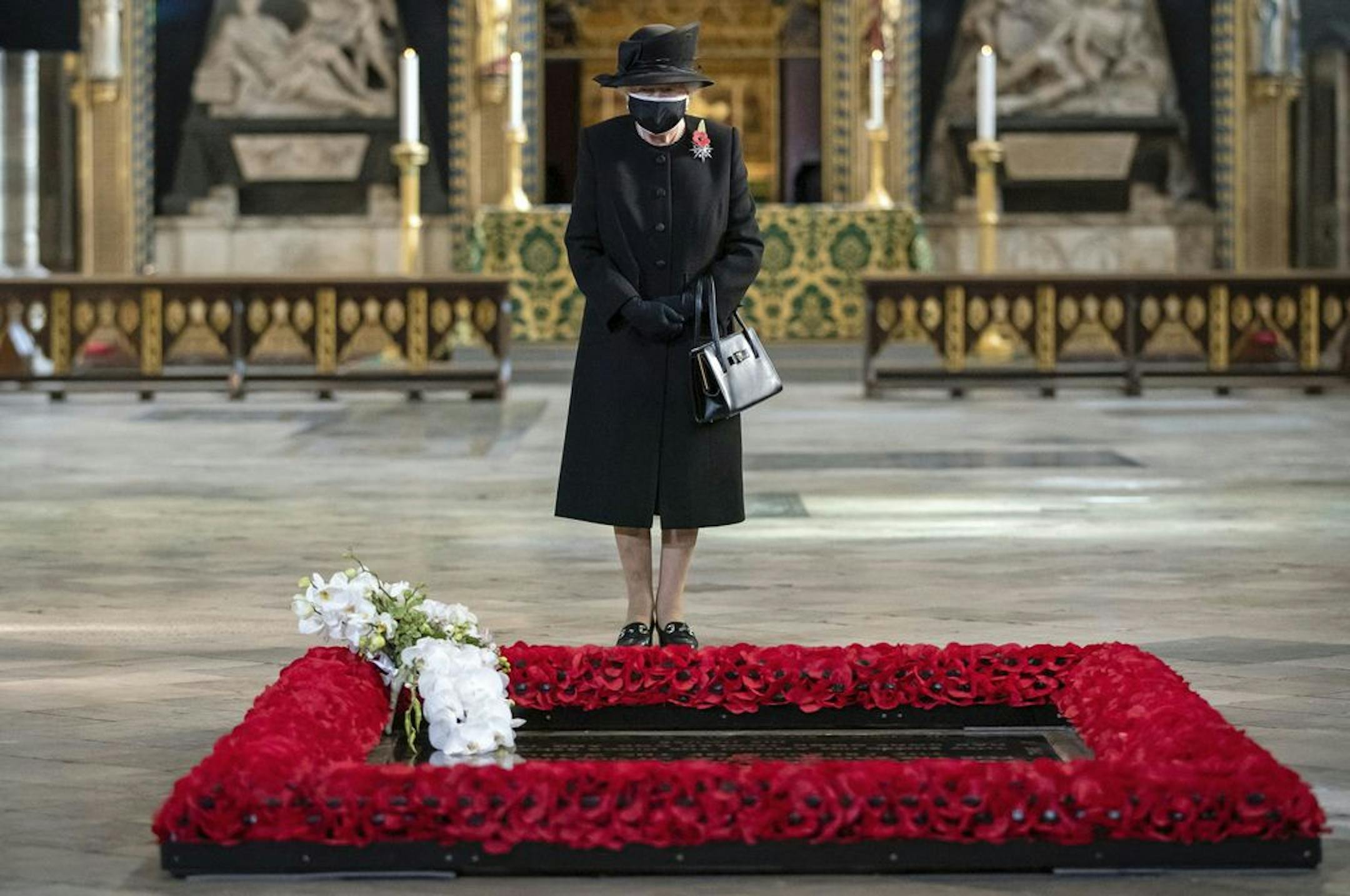 Britain's Queen Elizabeth II attends a ceremony to mark the centenary of the burial of the Unknown Warrior, in Westminster Abbey, London, Wednesday, Nov. 4, 2020. Queen Elizabeth II donned a face mask in public for the first time during the coronavirus pandemic when attending a brief ceremony at Westminster Abbey last week to mark the centenary of the burial of the Unknown Warrior. While the 94-year-old has been seen in public on several occasions over the past few months, she has not worn a fac