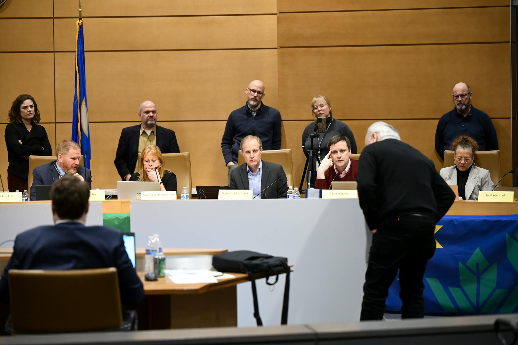 Members of the State Emblems Redesign Commission give feedback for the three finalist flags during a meeting Tuesday, Dec. 12, 2023 at the Minnesota Senate Building in St. Paul, Minn.. ] AARON LAVINSKY • aaron.lavinsky@startribune.com