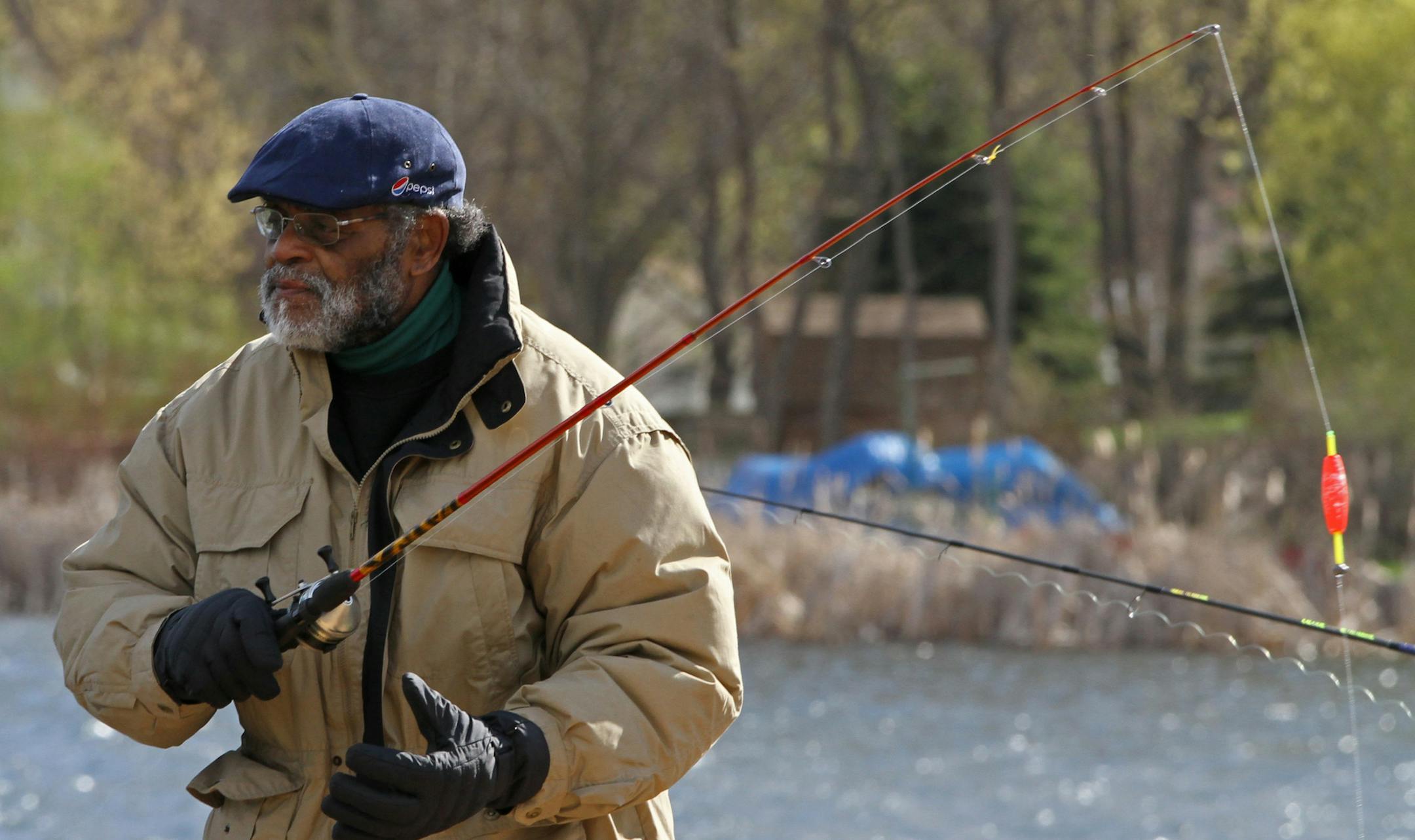 Eugene Smith, of Minneapolis fished from the boat launch near Crystal Bay at Lake Minnetonka, on a cold and windy fishing opener on 5/11/13.] Bruce Bisping/Star Tribune bbisping@startribune.com