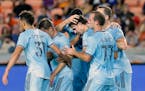 Minnesota United midfielder Adrien Hunou, center, celebrates with teammates after scoring a goal against the Houston Dynamo during the first half Satu
