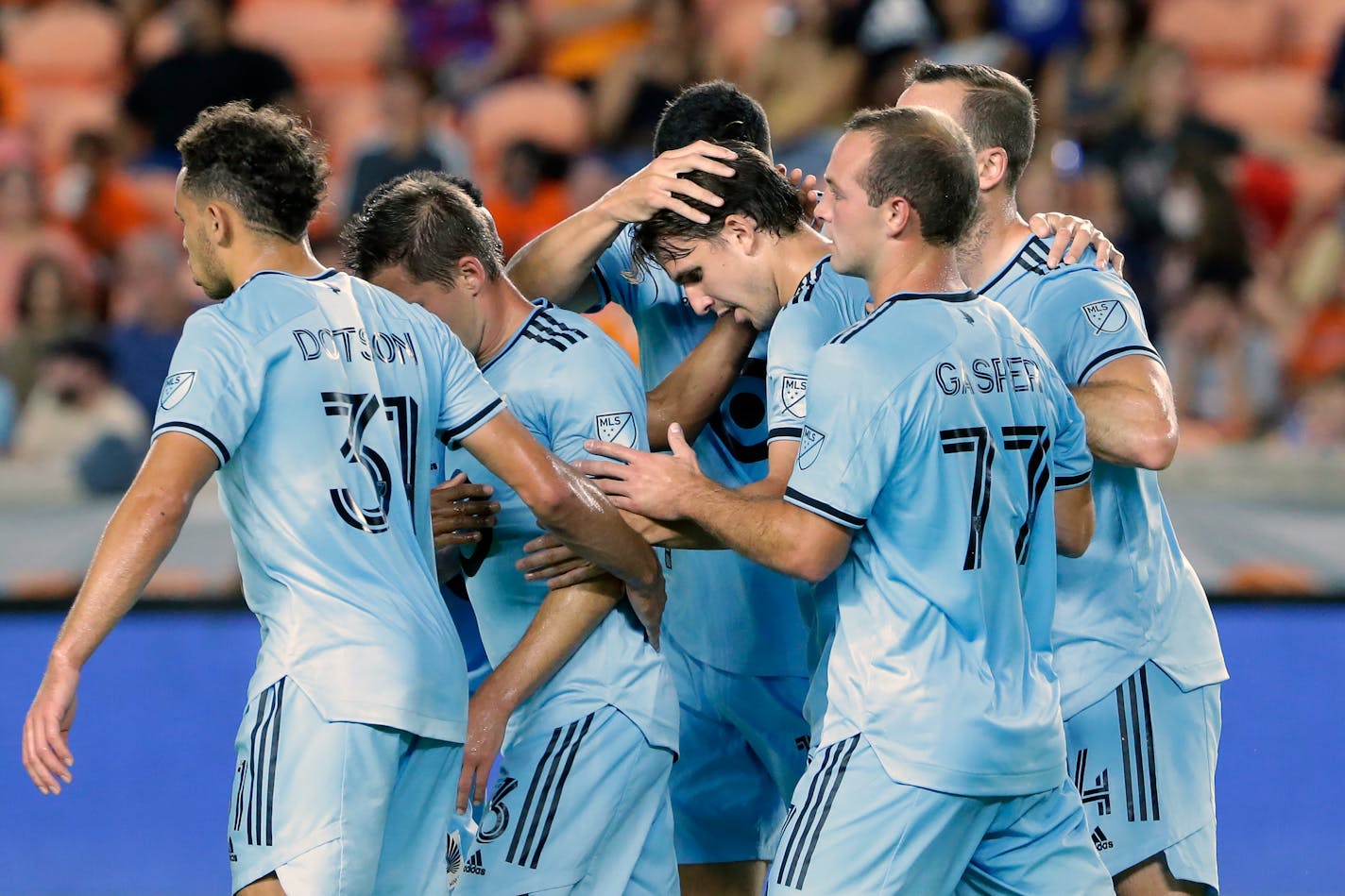 Minnesota United midfielder Adrien Hunou, center, celebrates with teammates after scoring a goal against the Houston Dynamo during the first half Saturday.