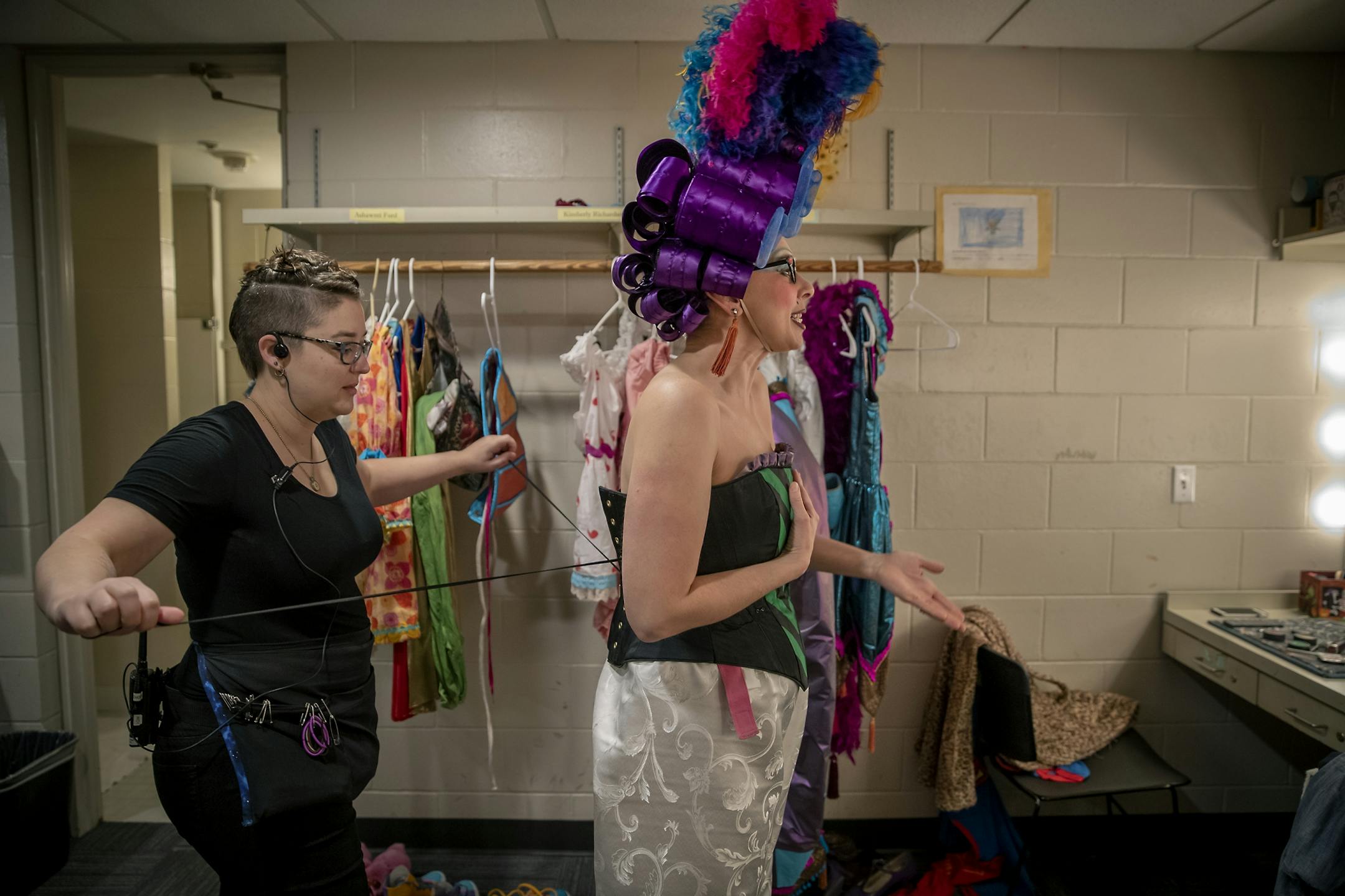 Children's Theatre Company's Andi Soehren tightened a corset onto actor Autumn Ness as they got ready in the dressing room for a dress rehearsal for the Theatre's production of "Cinderella," Friday, November 1, 2019.