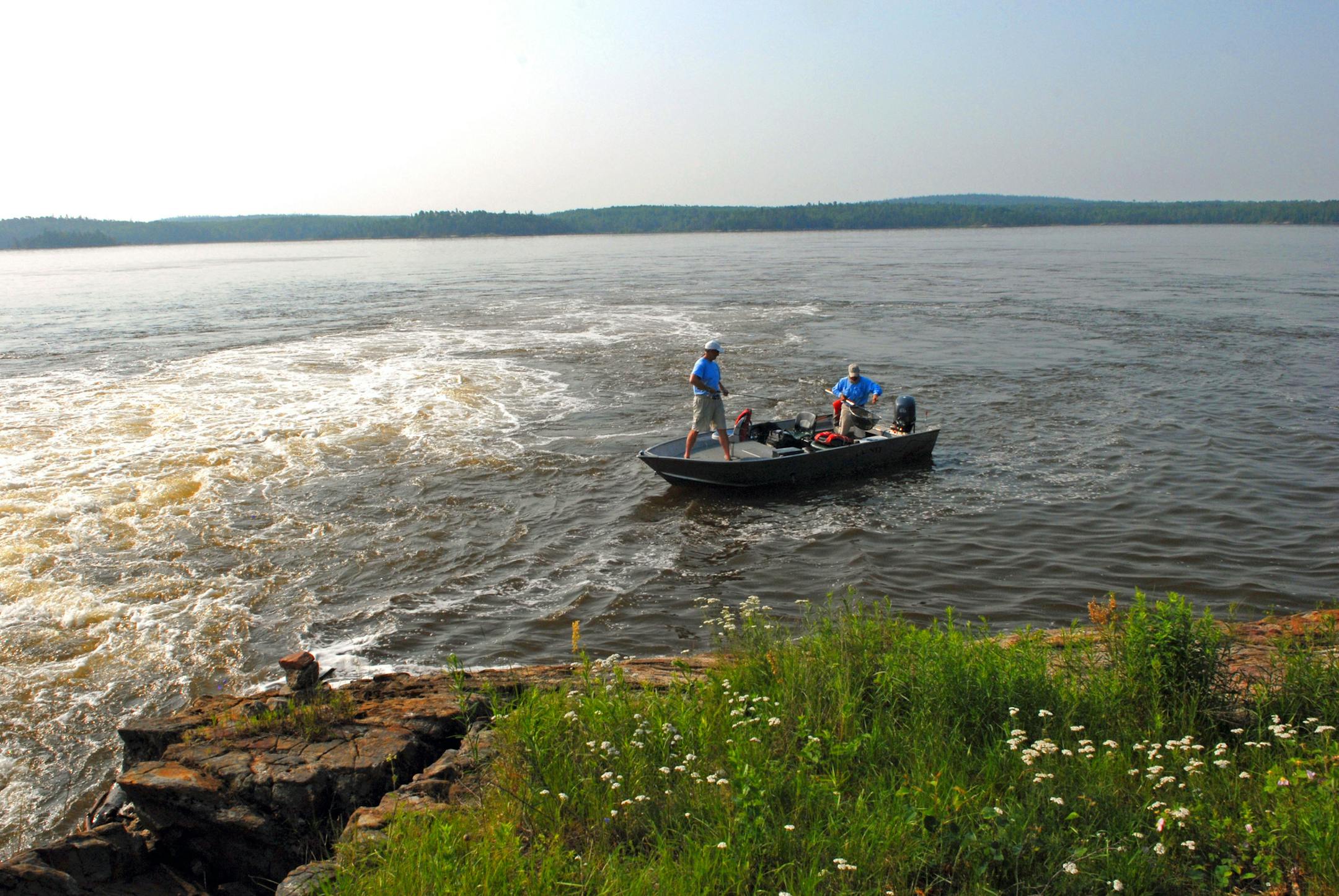 Mike Murphy of Woodbury lands one of many walleyes he hooked beneath the falls of the English River as it enters Oak Lake, Ontario. Guide Isador Belvin in the stern netted the fish.