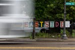 A sign spelling “Eastside” rests on a fence on Payne Avenue in the Payne-Phalen neighborhood on in St. Paul on Friday, June 21.