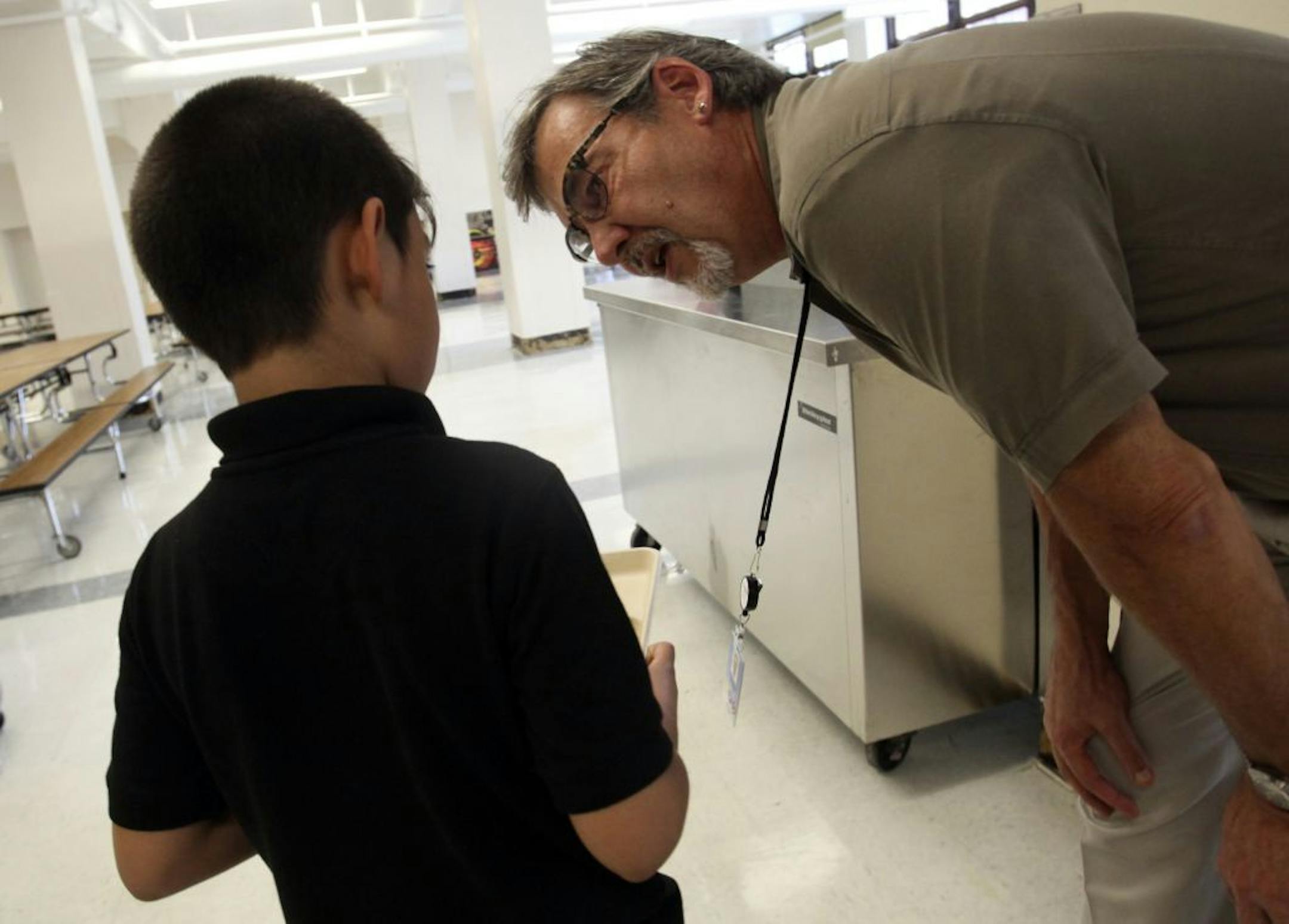 Minneapolis School District nutrition director Bertrand Weber suggested to a young student that he go back for fruit and vegetables in the lunch line.