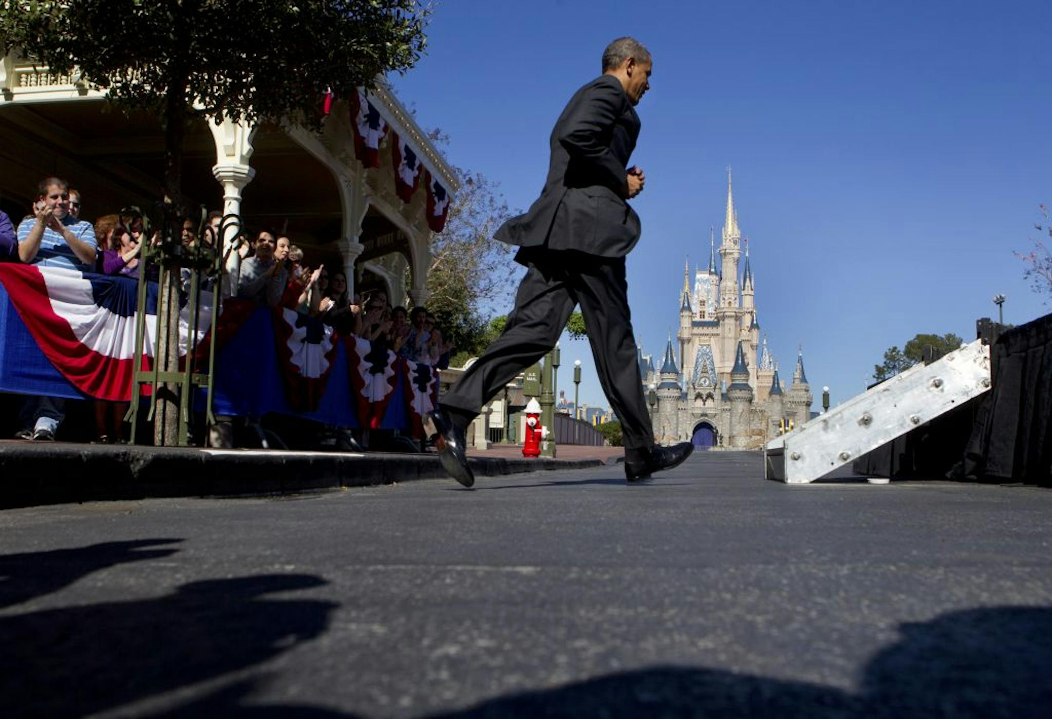 President Obama hustled to the podium Thursday at Walt Disney World. "People want to come here," the president said, referring to the United States.