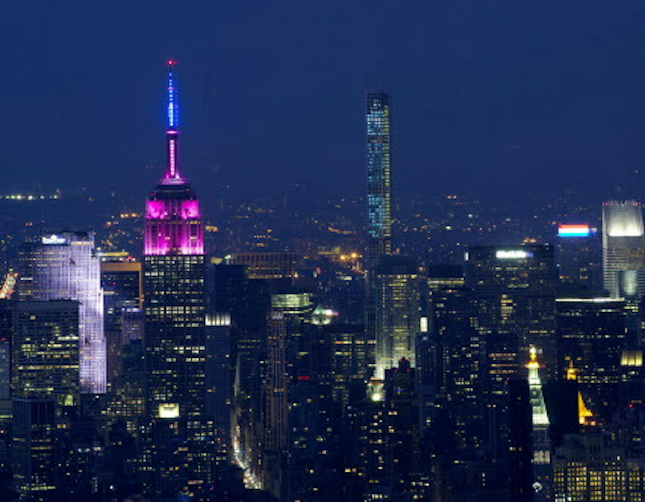 The Empire State Building, left, and 432 Park Ave., center, dominate the midtown Manhattan skyline, Saturday, July 4, 2015 in New York in a view from One World Observatory. (AP Photo/Mark Lennihan)