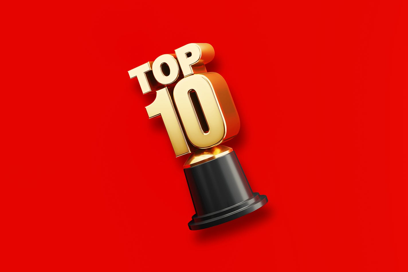 Gold colored top ten award sitting on red background. Horizontal composition with copy space. Directly above view. Top 10 concept.