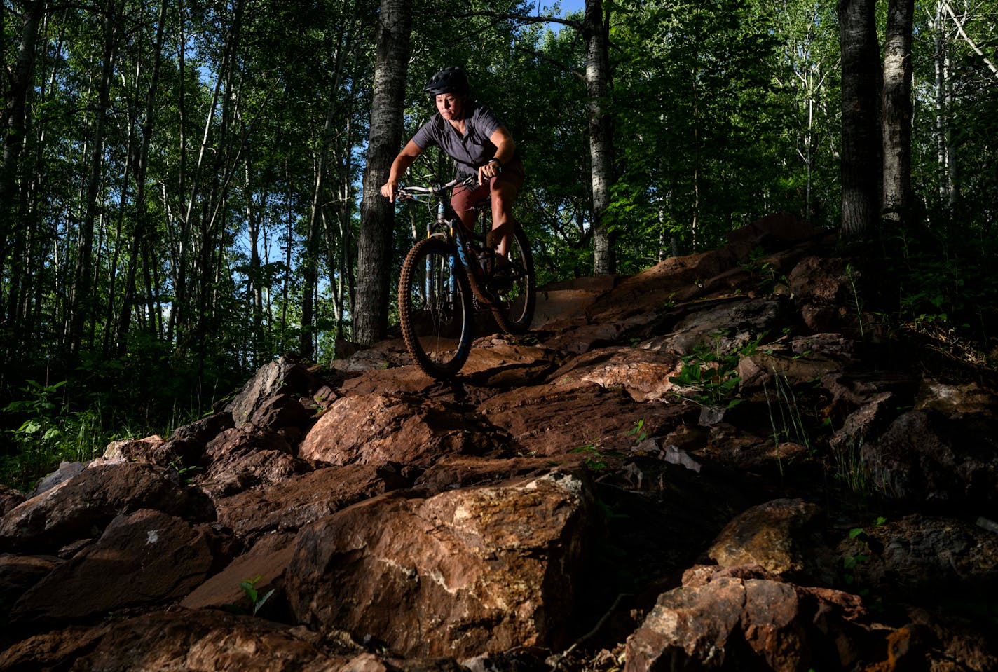 Mari Kivisto, an energy technologist and avid mountain biker from Deerwood, made her way down a rock wall on the Drawpoint Trail Tuesday night at the Cuyuna Country State Recreation Area. "Mountain biking gave me a community and something to do that was positive," said Kivisto. She used to coach ball sports, but "coaching mountain biking is so much more regarding." Kivisto sometimes works as a mountain biking guide.