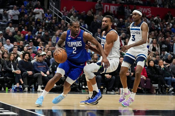 Los Angeles Clippers forward Kawhi Leonard (2) dribbles past Minnesota Timberwolves center Rudy Gobert (27) during the second half of an NBA basketbal