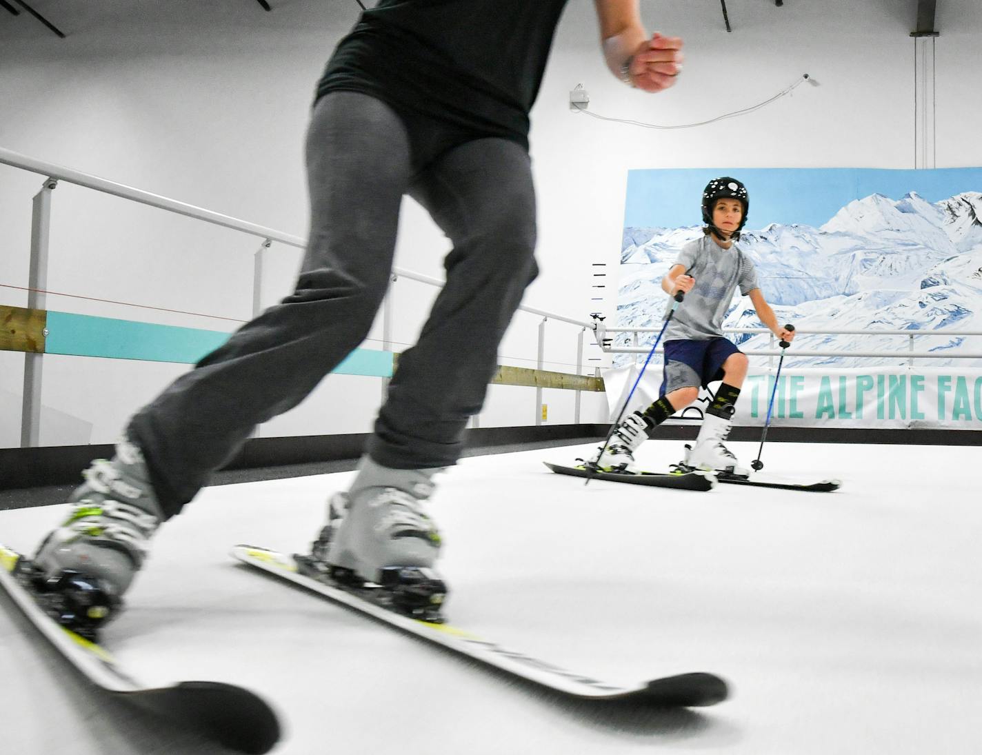 Alpine Factory owner Jessica Parcheta moved back and forth as she helped Henry Schwartz, 12, with his form on the fast moving slope. ] GLEN STUBBE &#x2022; glen.stubbe@startribune.com Thursday July 6, 2017 It may be the middle of the dog days of summer. But in Arden Hills, there's a new downhill ski center that will never be affected by global warming, where winter never ends and the ski runs go on forever. That's because the Alpine Factory is a warehouse with two enormous ski treadmills where y