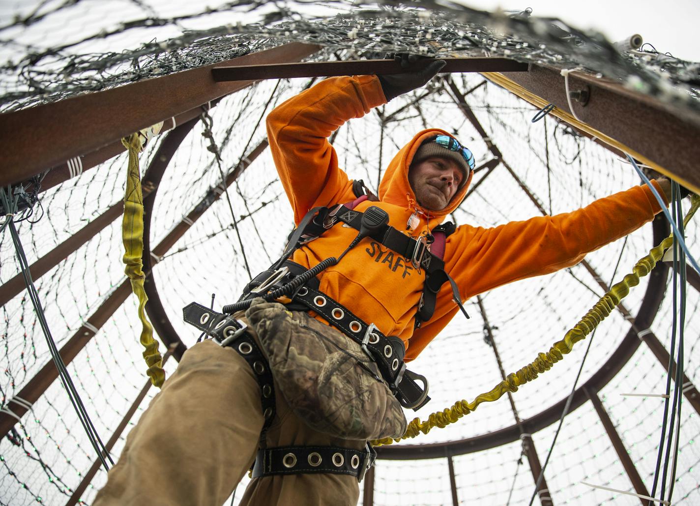 Rusty Rookey worked on hanging the Christmas light laced chicken wire on the outside of the large Bentleyville Christmas Tree on October 19, 2019. ]
ALEX KORMANN &#x2022; alex.kormann@startribune.com Bentleyville has brought together the same core group of volunteers, like a family, together every year since it first began in Duluth 11 years ago.