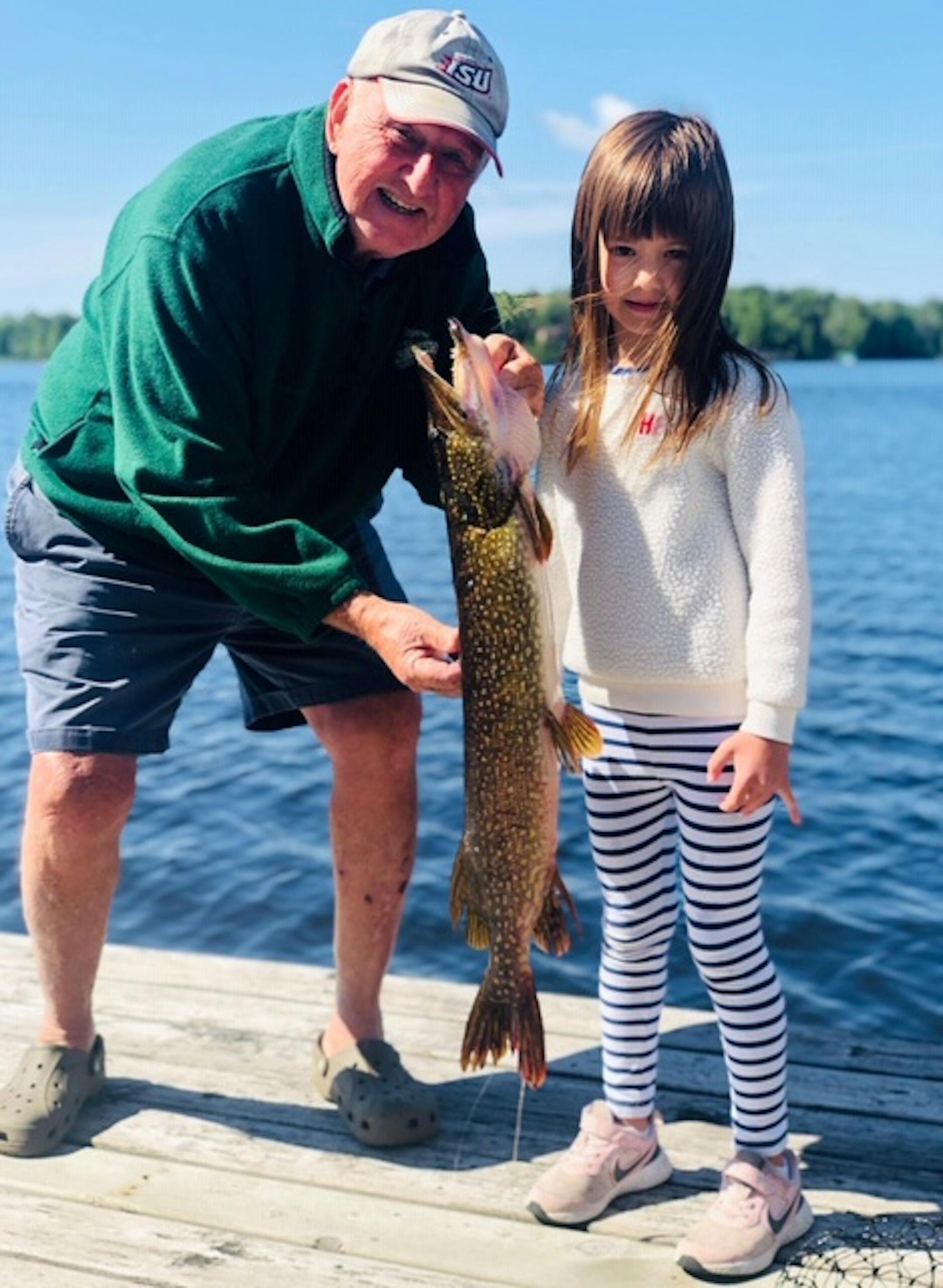 Reese Mahlum, age 5, of Delano, caught this northern from the dock at the family cabin on Island Lake near Duluth, with a little help from her grandfather Dan Laurila, of Edina.