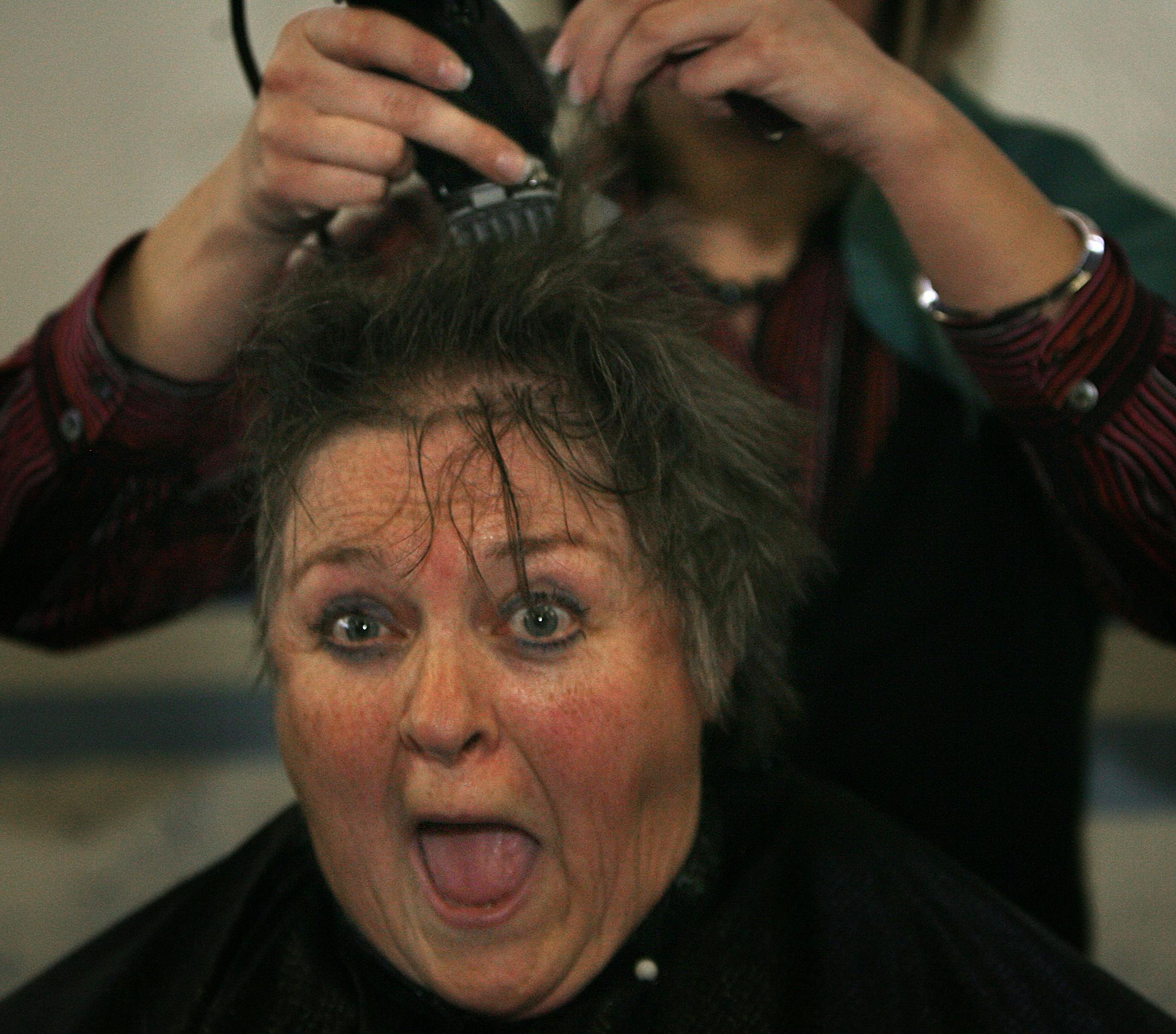 Jien Lindholm, who teaches middle school math and social studies, had her head shaved Friday while St. Helena students cheered.