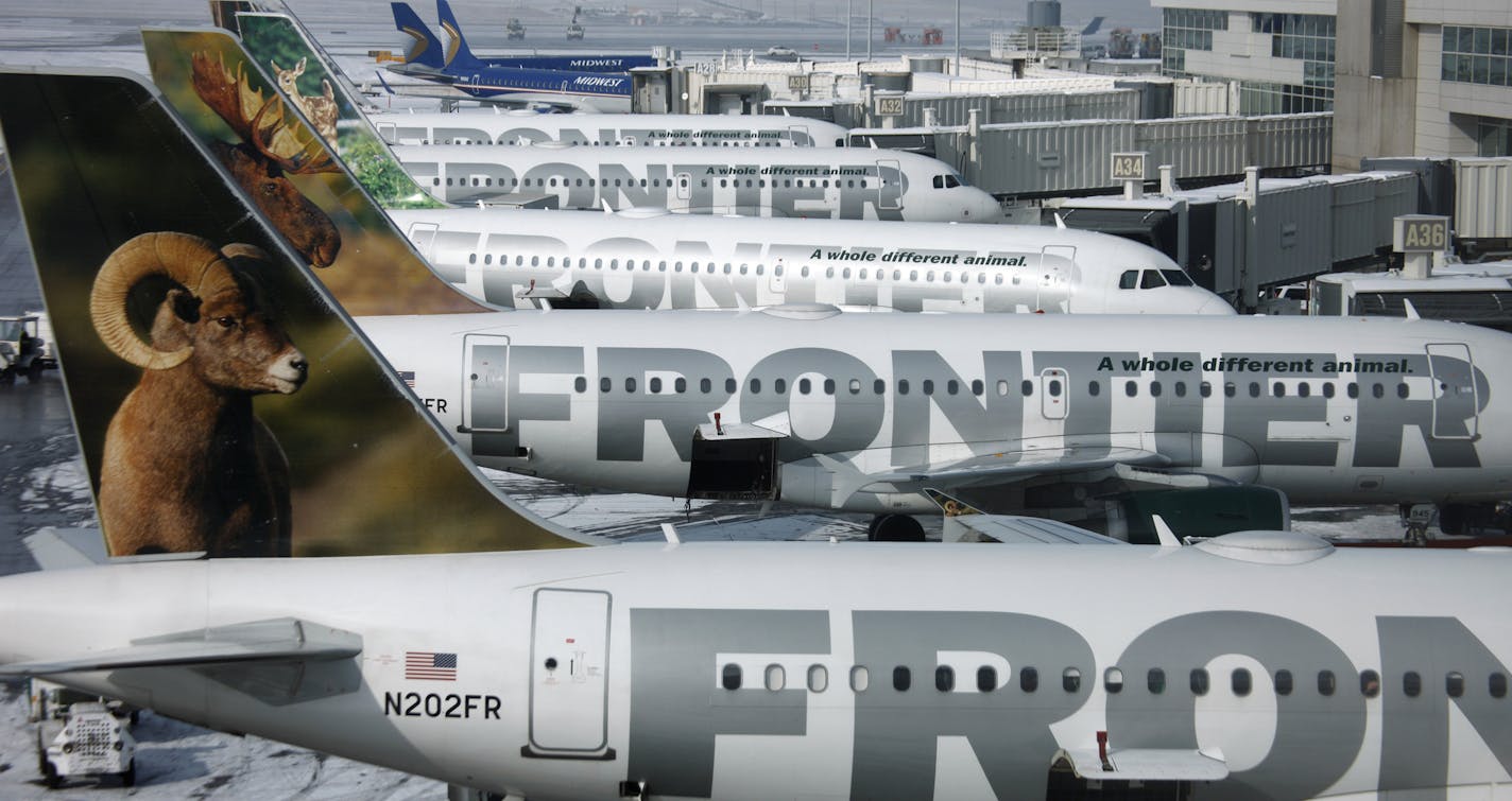 FILE - In this Feb. 22, 2010 file photo, Frontier Airlines jetliners sit stacked up at gates along the A concourse at Denver International Airport. Passengers flying Frontier Airlines will now have to pay extra to place carry-on bags in overhead bins or for advance seat assignments. The move comes as the Denver-based airline transforms itself into a fee-dependent airline, similar to Spirit Airlines or Allegiant Air _ the only other U.S. carriers to charge such fees. (AP Photo/David Zalubowski, F