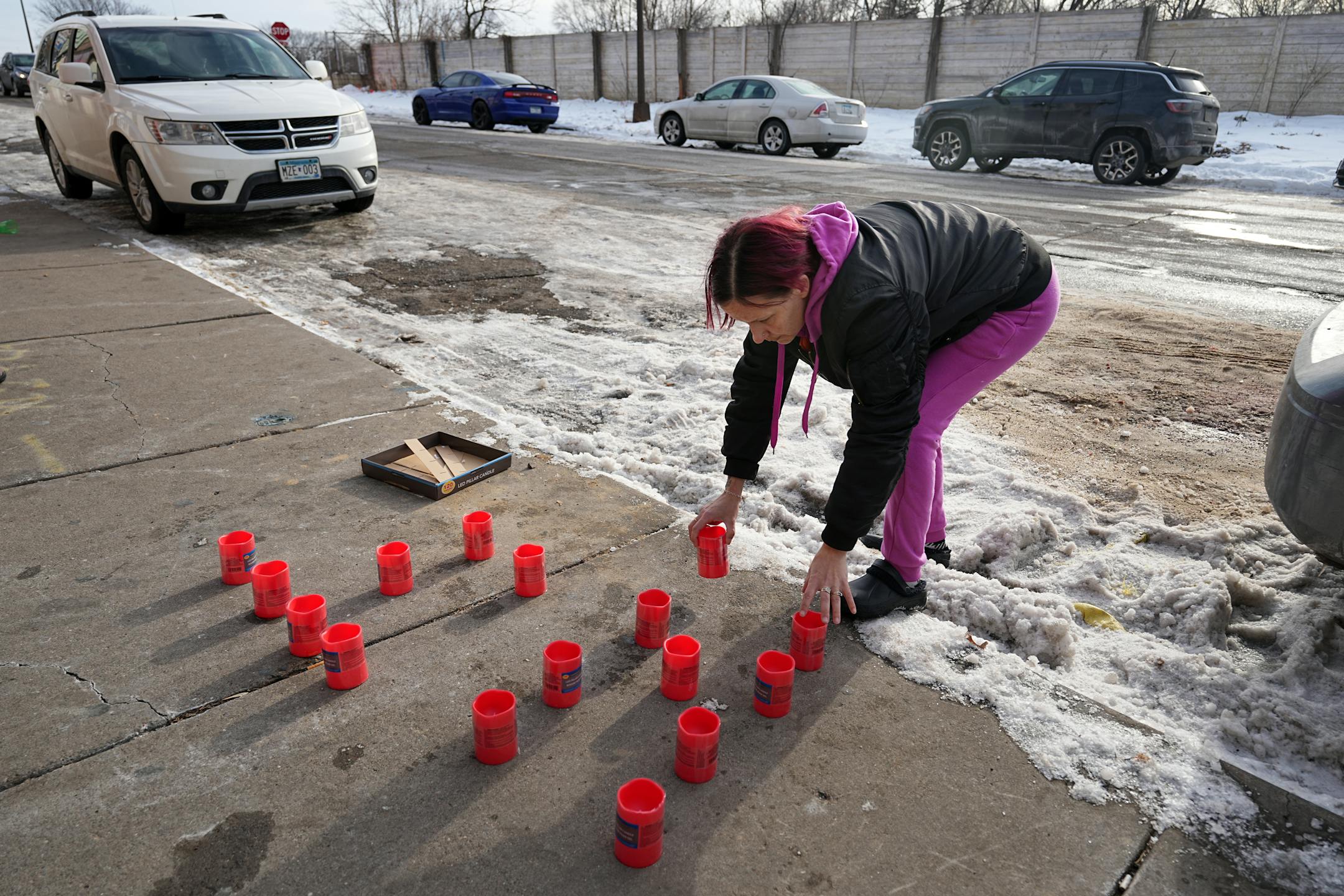 Tonya Medvec placed candles at the site where her nephew, Howard Johnson, was shot and killed by St. Paul Police.