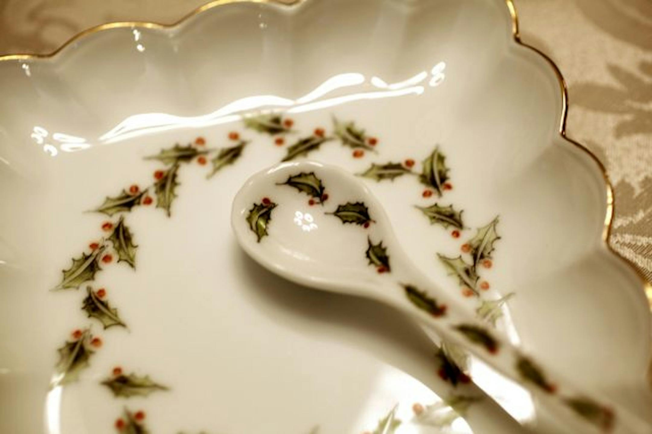 One of Marlyn Ingman's painted sets includes a leaf design on spoons, plates and stemware.