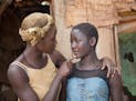 In this image released by Disney, Lupita Nyong'o, left, and Madina Nalwanga appear in a scene from "Queen of Katwe." (Edward Echwalu/Disney via AP)
