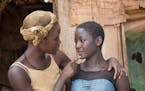 In this image released by Disney, Lupita Nyong'o, left, and Madina Nalwanga appear in a scene from "Queen of Katwe." (Edward Echwalu/Disney via AP)